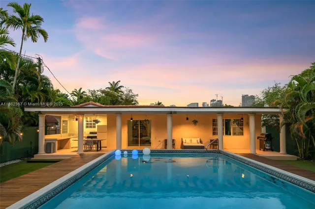 front view of house with swimming pool yard and outdoor seating