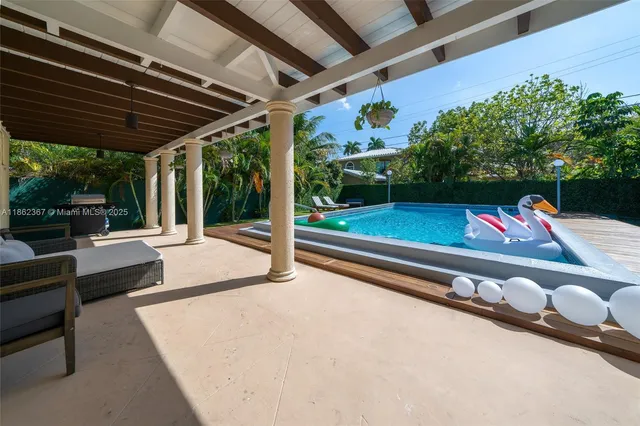 a view of swimming pool with a patio