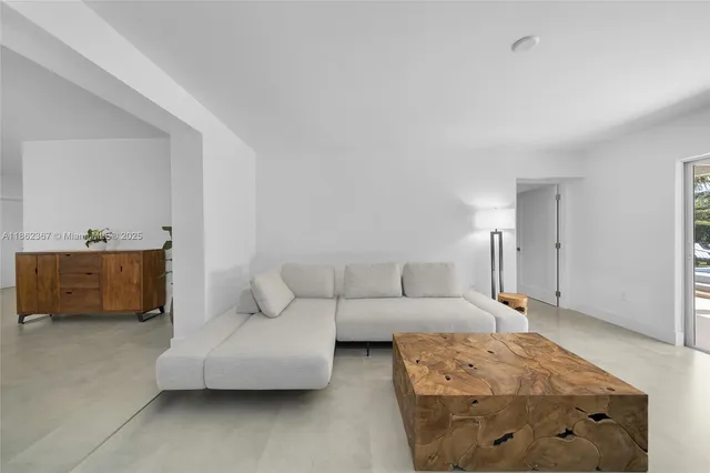 a living room with furniture and a lamp