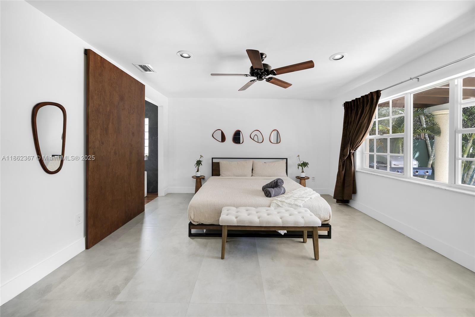 620 Southwest 22nd Road Miami, FL 33129 - Photo 6 of 31 a bedroom with a bed and window