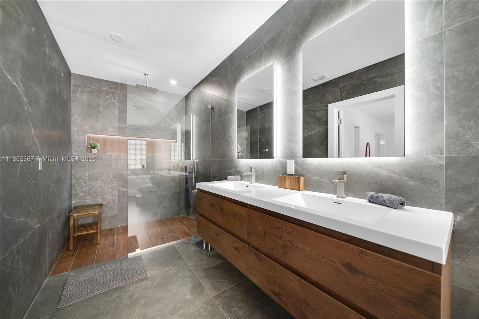 620 Southwest 22nd Road Miami, FL 33129 - Photo 9 of 31 a bathroom with a double vanity sink and a mirror