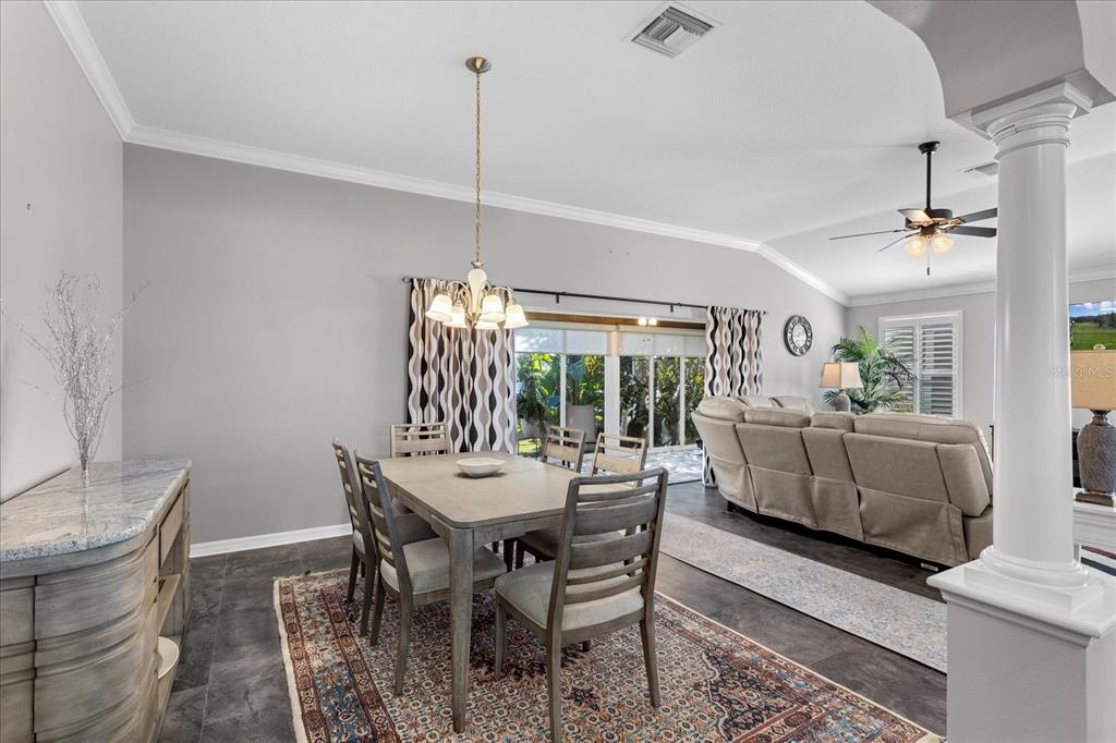 566 Allenwood Loop The Villages, FL 32162 - Photo 11 of 32 a view of a dining room and livingroom with furniture wooden floor a chandelier