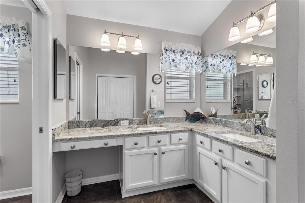 566 Allenwood Loop The Villages, FL 32162 - Photo 19 of 32 a bathroom with a granite countertop sink vanity granite and a mirror