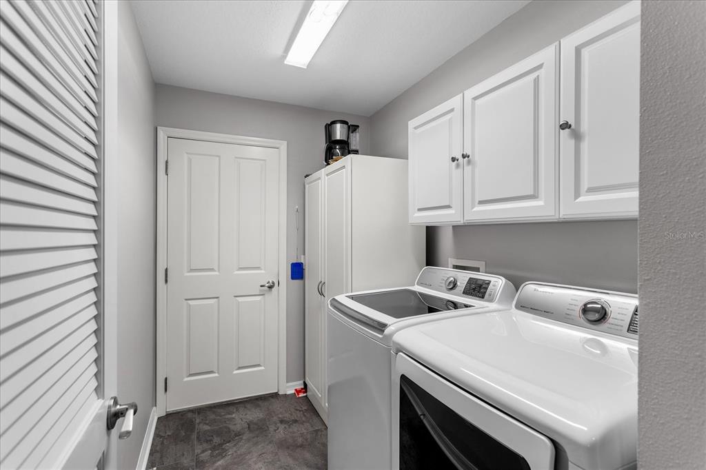 566 Allenwood Loop The Villages, FL 32162 - Photo 30 of 32 a utility room with dryer and washer