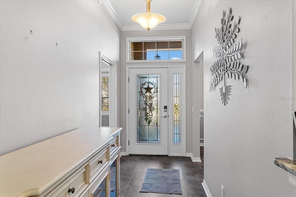 566 Allenwood Loop The Villages, FL 32162 - Photo 5 of 32 a room with window and chandelier