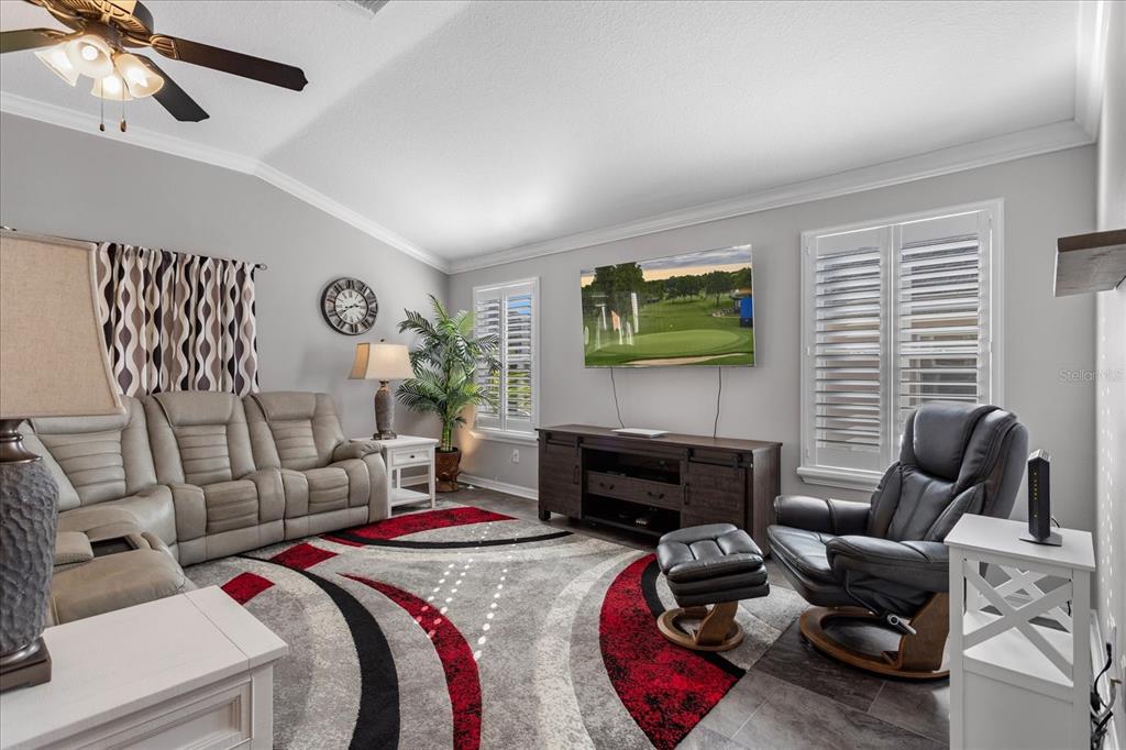 566 Allenwood Loop The Villages, FL 32162 - Photo 6 of 32 a bedroom with furniture and a flat screen tv