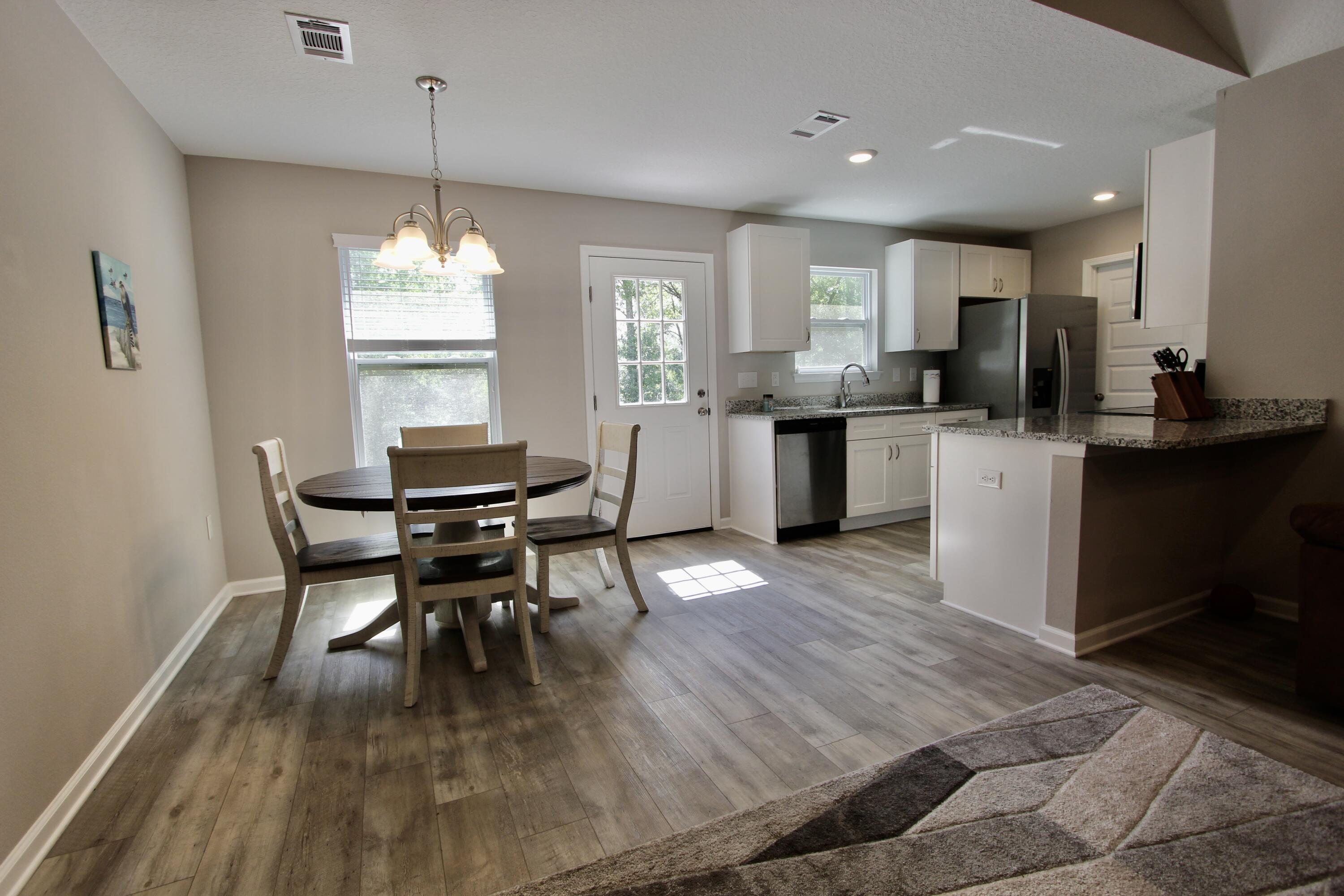 102 Windsor Drive Crestview, FL 32539 - Photo 13 of 26 a kitchen with a dining table chairs and white cabinets