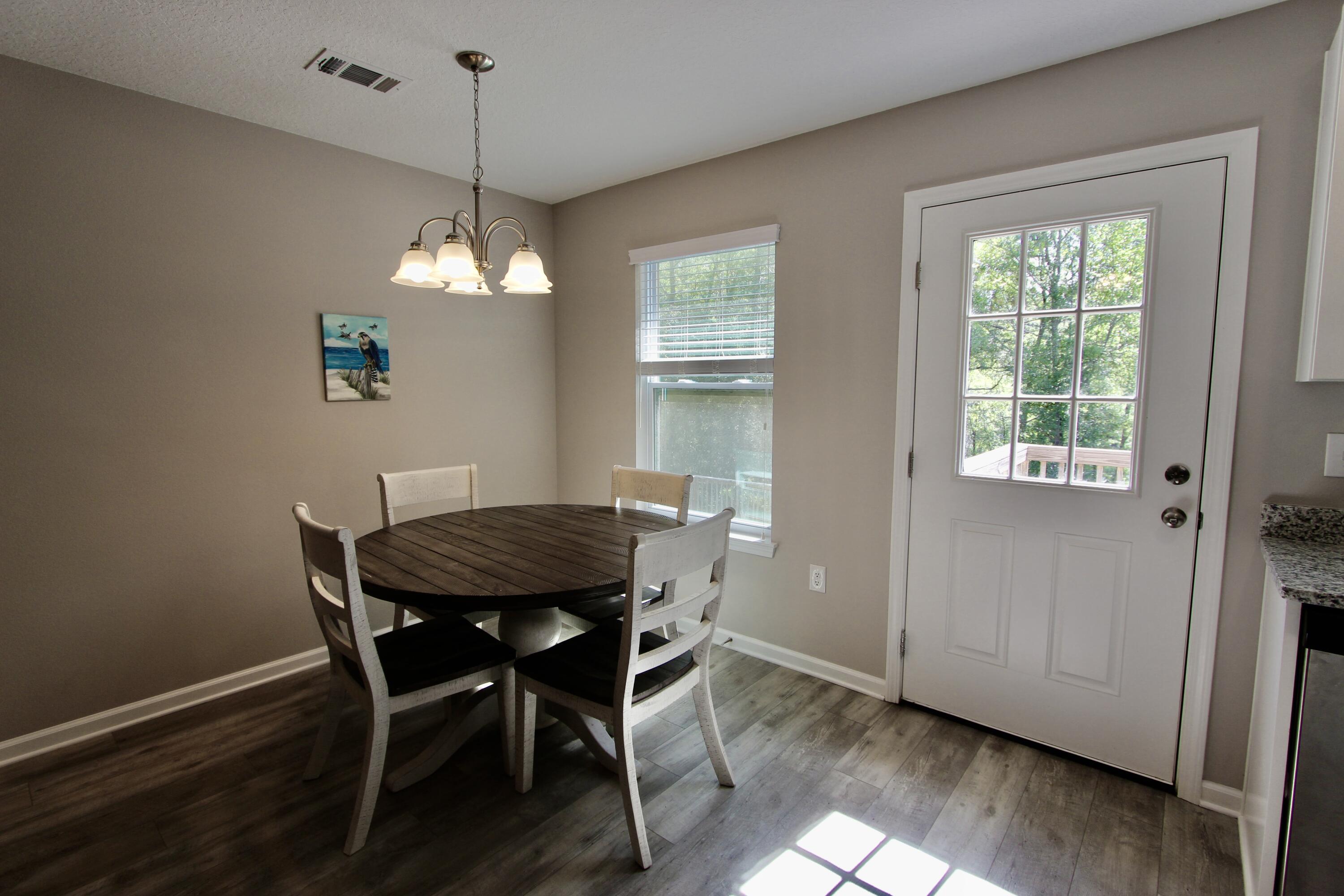102 Windsor Drive Crestview, FL 32539 - Photo 14 of 26 a view of a dining room with furniture window and wooden floor