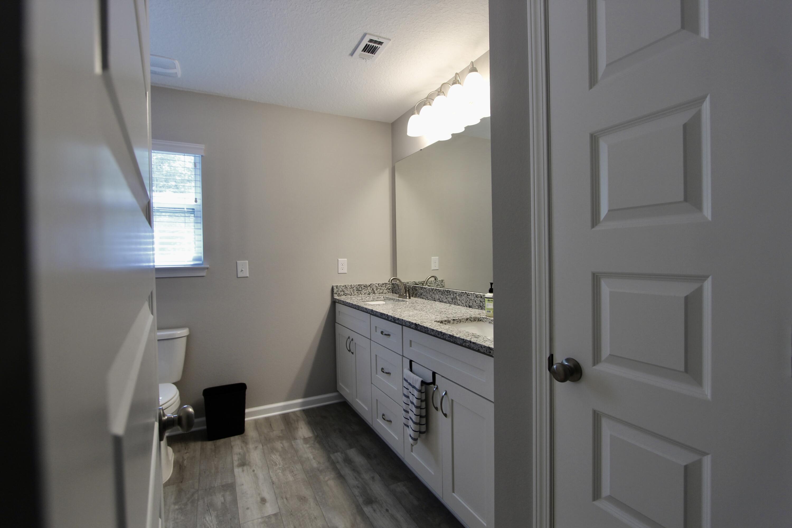 102 Windsor Drive Crestview, FL 32539 - Photo 19 of 26 a bathroom with a double vanity sink and a mirror