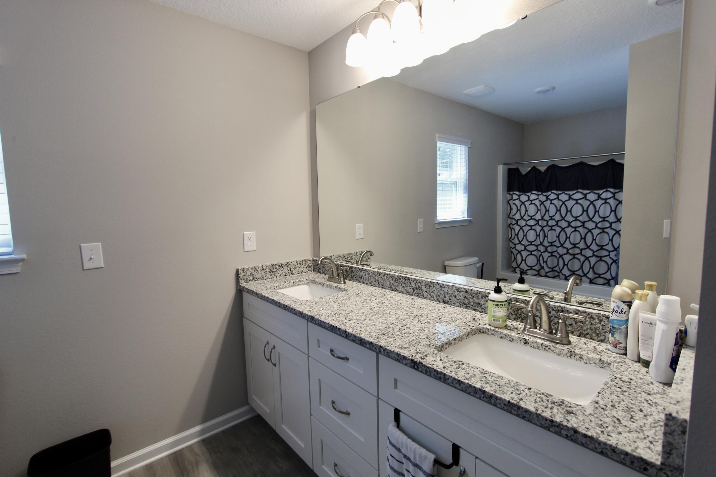 102 Windsor Drive Crestview, FL 32539 - Photo 20 of 26 a bathroom with a granite countertop sink and a mirror