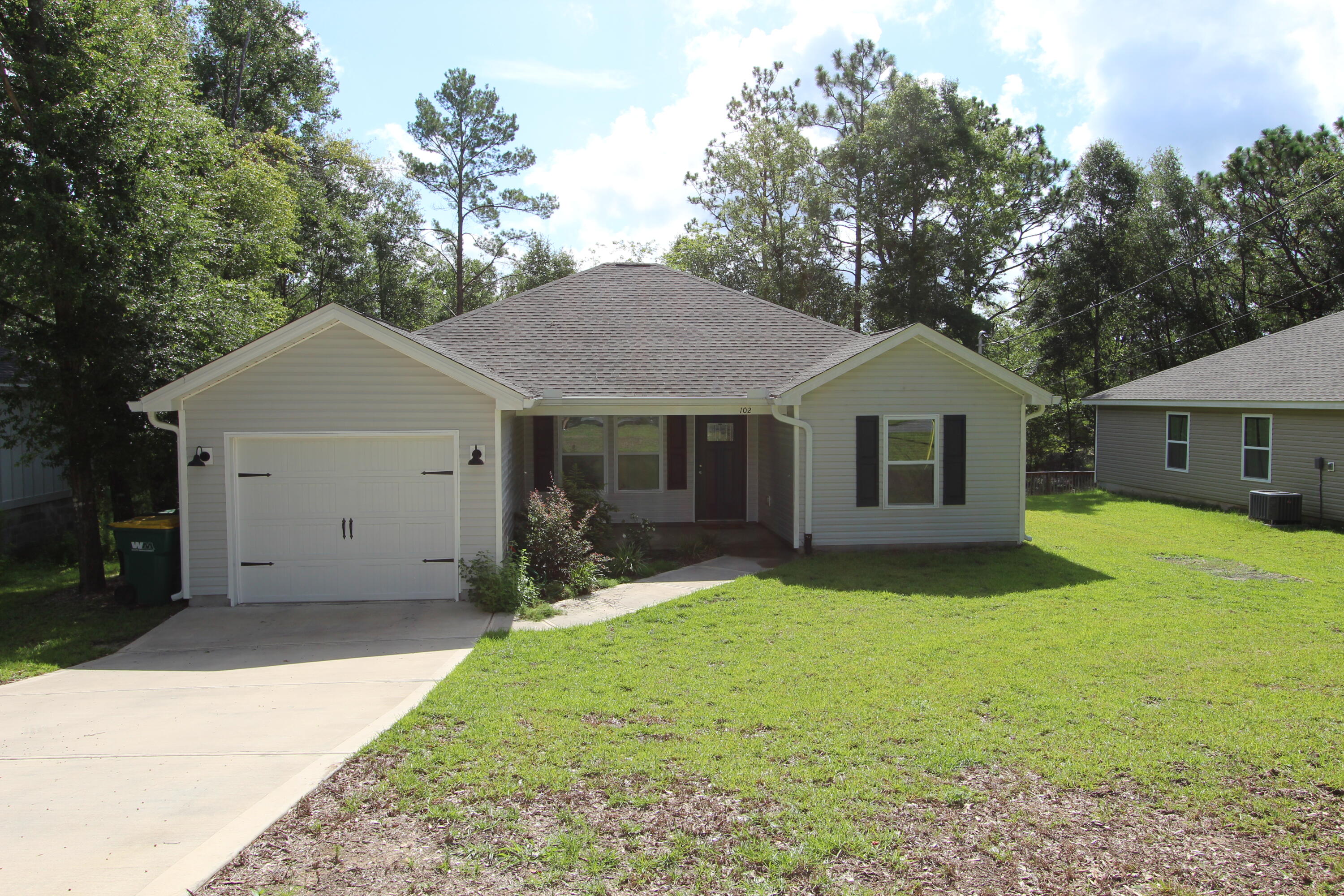 102 Windsor Drive Crestview, FL 32539 - Photo 3 of 26 a front view of a house with a garden and yard