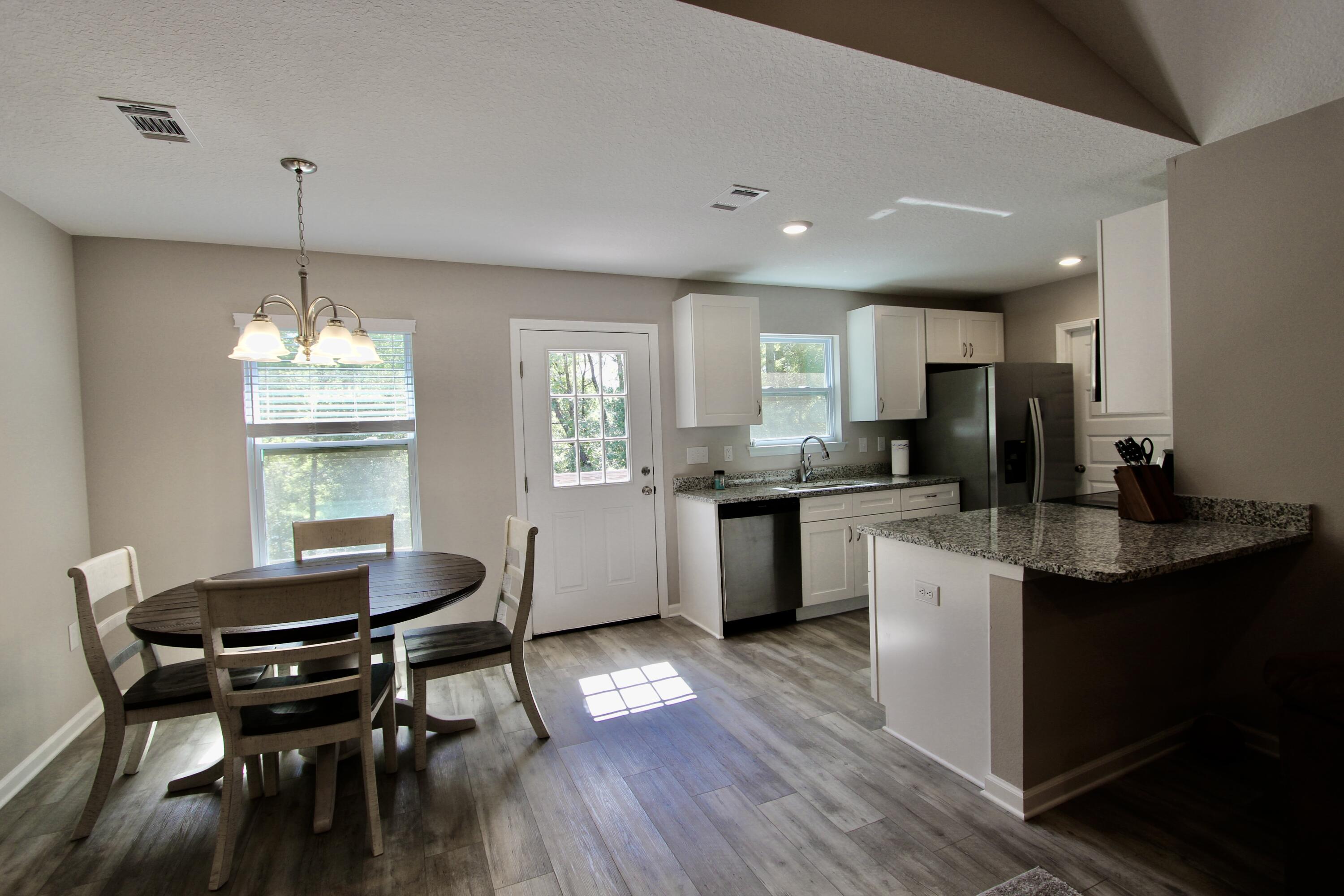 102 Windsor Drive Crestview, FL 32539 - Photo 10 of 26 a kitchen with a dining table chairs stove and cabinets