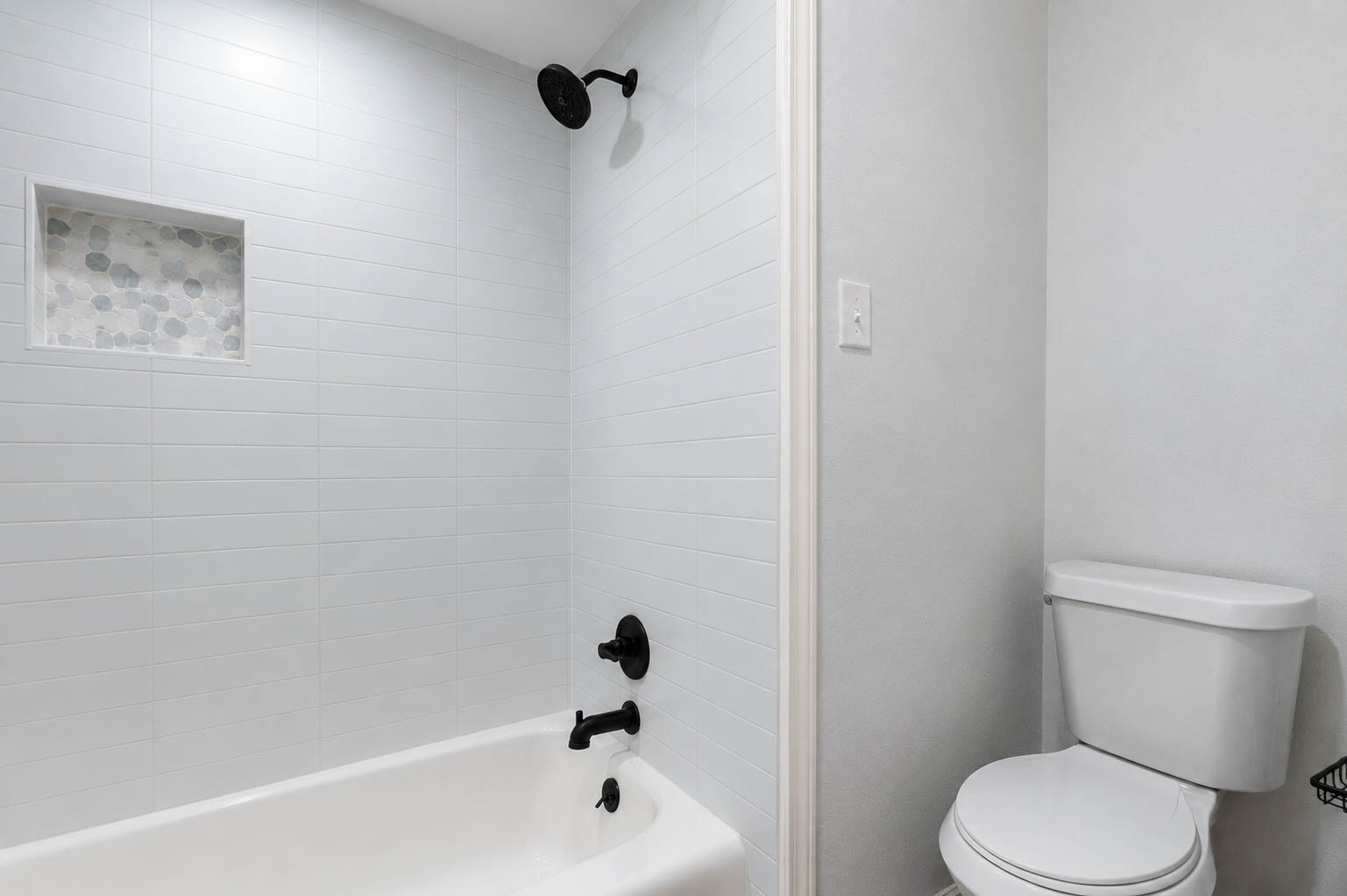 630 South Fry Road Katy, TX 77450 - Photo 31 of 48 Sleek and modern bathroom featuring a stylish black-framed mirror, elegant black fixtures, and ample storage with a crisp white vanity.