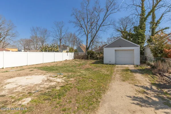 a view of a yard with a large tree