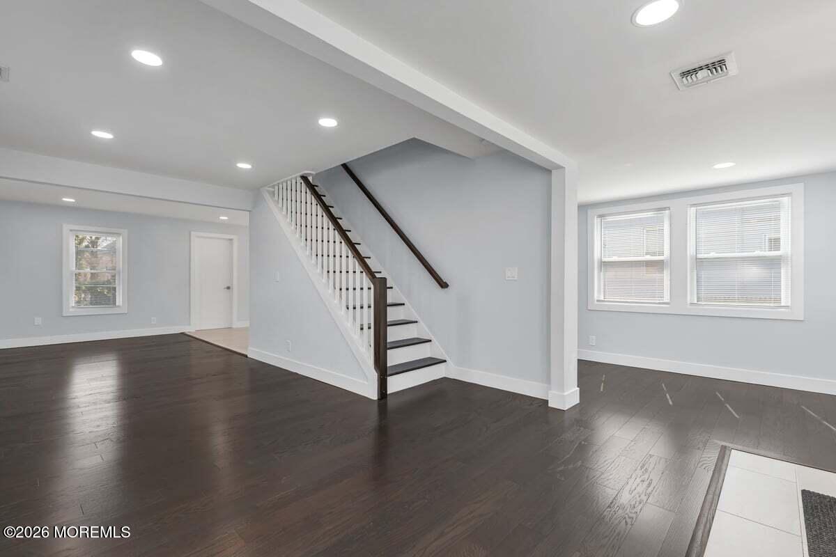 25 Howland Place Long Branch, NJ 07740 - Photo 3 of 13 an empty room with wooden floor and windows