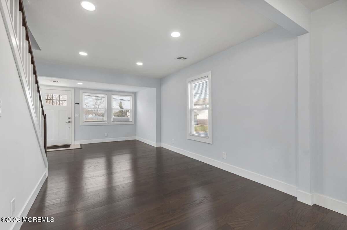 25 Howland Place Long Branch, NJ 07740 - Photo 4 of 13 an empty room with wooden floor and windows