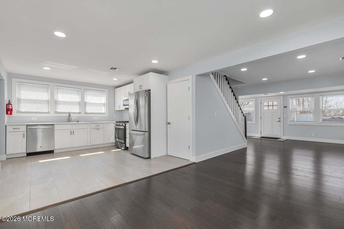25 Howland Place Long Branch, NJ 07740 - Photo 5 of 13 a view of an empty room with wooden floor and a kitchen