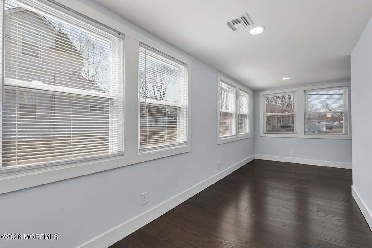 25 Howland Place Long Branch, NJ 07740 - Photo 6 of 13 a view of an empty room with wooden floor and windows