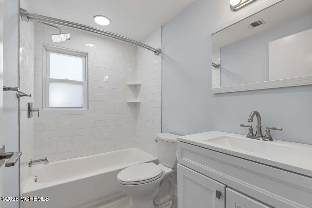 25 Howland Place Long Branch, NJ 07740 - Photo 7 of 13 a bathroom with a sink a toilet and shower