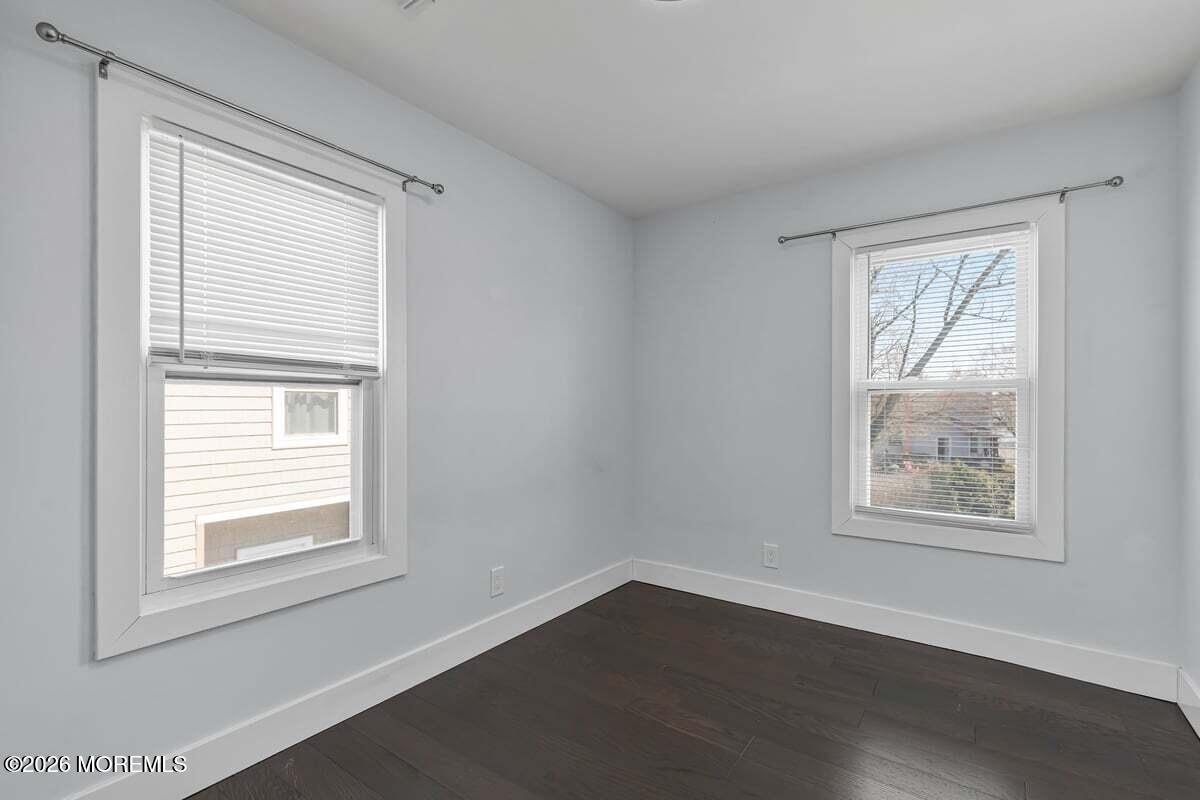 25 Howland Place Long Branch, NJ 07740 - Photo 9 of 13 a view of an empty room with wooden floor and a window
