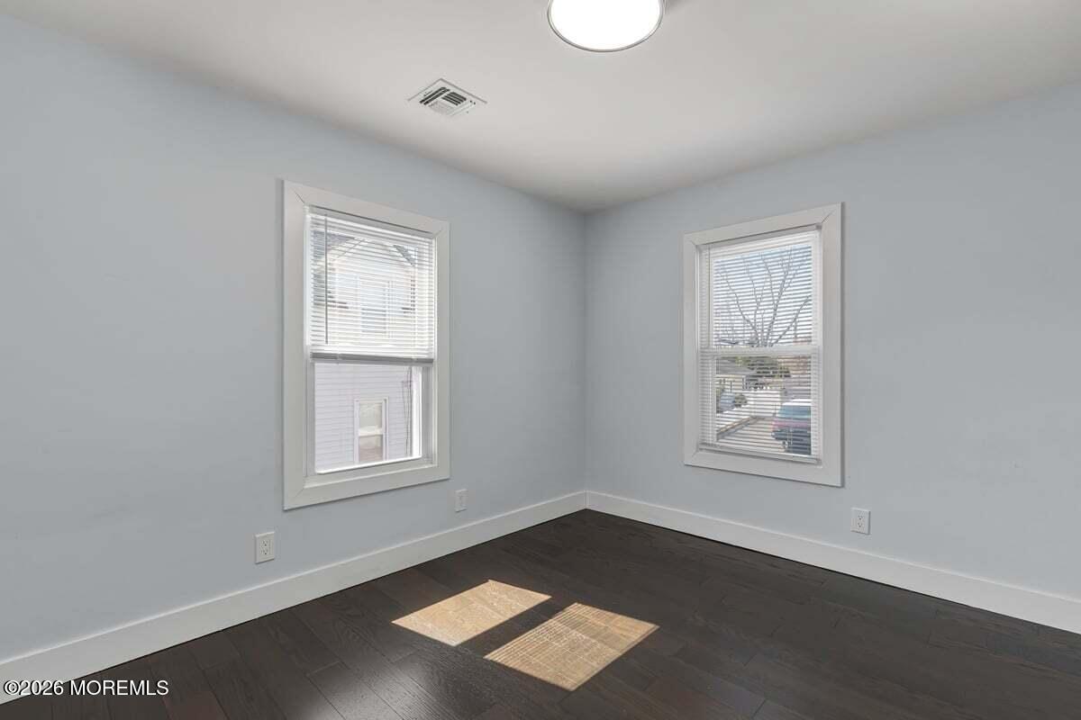 25 Howland Place Long Branch, NJ 07740 - Photo 10 of 13 a view of wooden floor and windows in a room