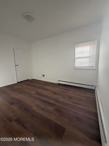 a view of room with wooden floor