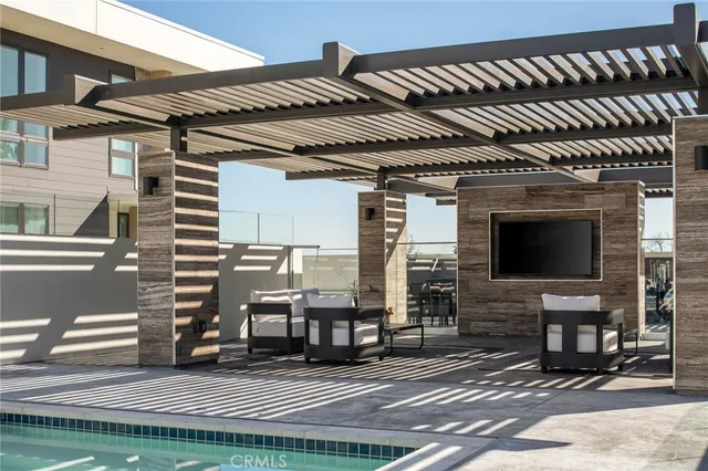 a view of a patio with table and chairs a barbeque with wooden floor and fence