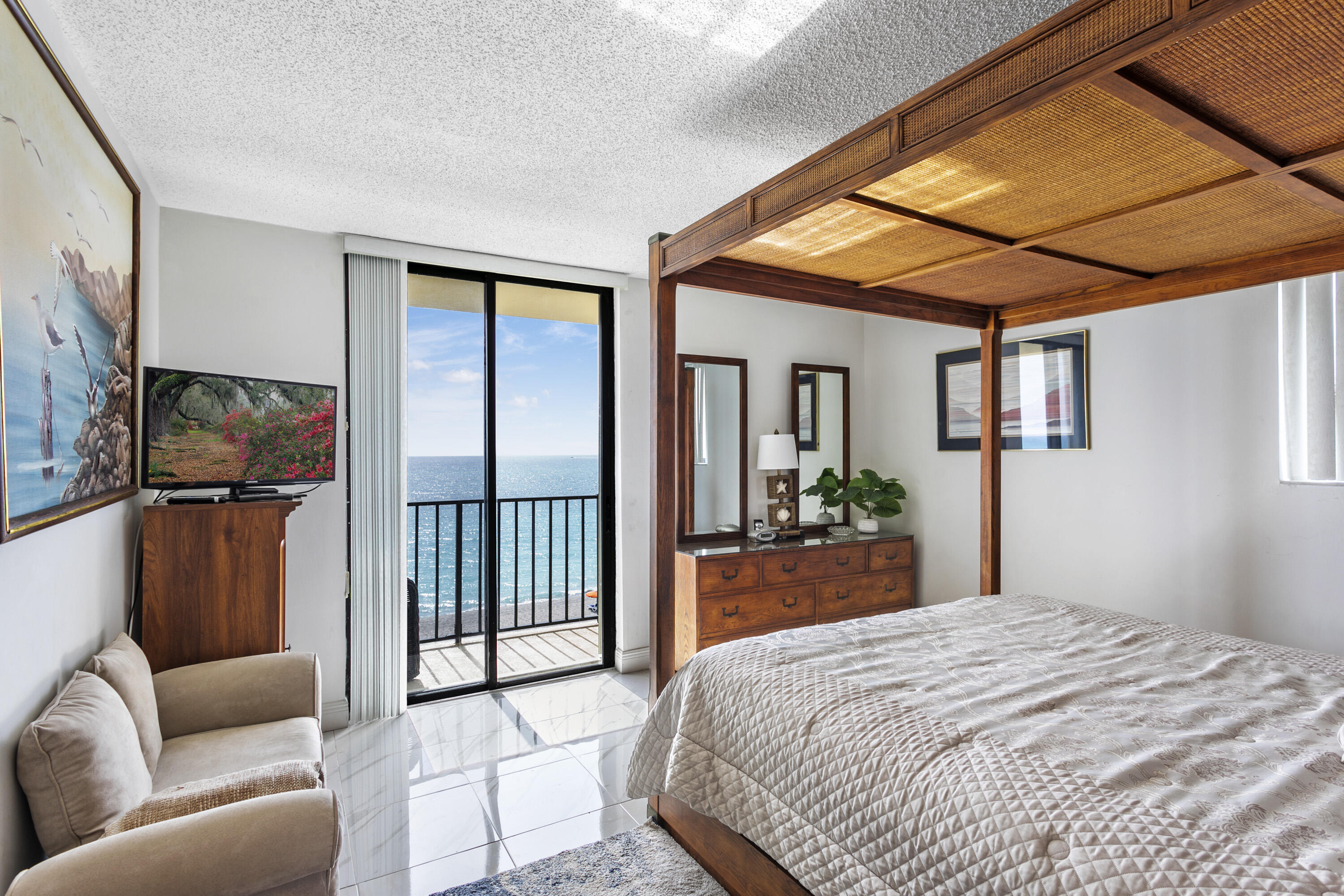 100 Ocean Trail Way, Unit 501 Jupiter, FL 33477 - Photo 12 of 30 a bedroom with furniture and large windows