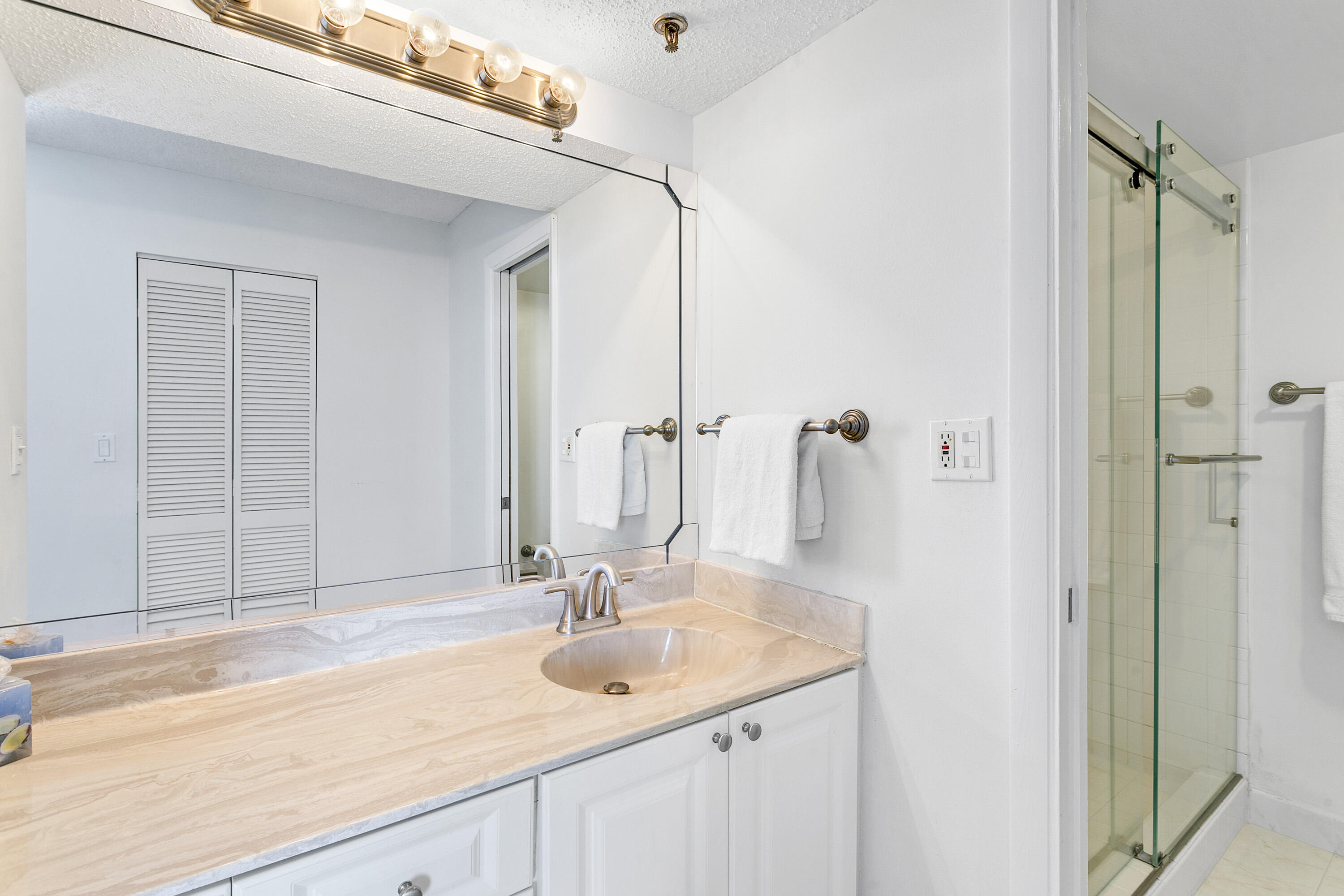 100 Ocean Trail Way, Unit 501 Jupiter, FL 33477 - Photo 15 of 30 a bathroom with a sink and a mirror