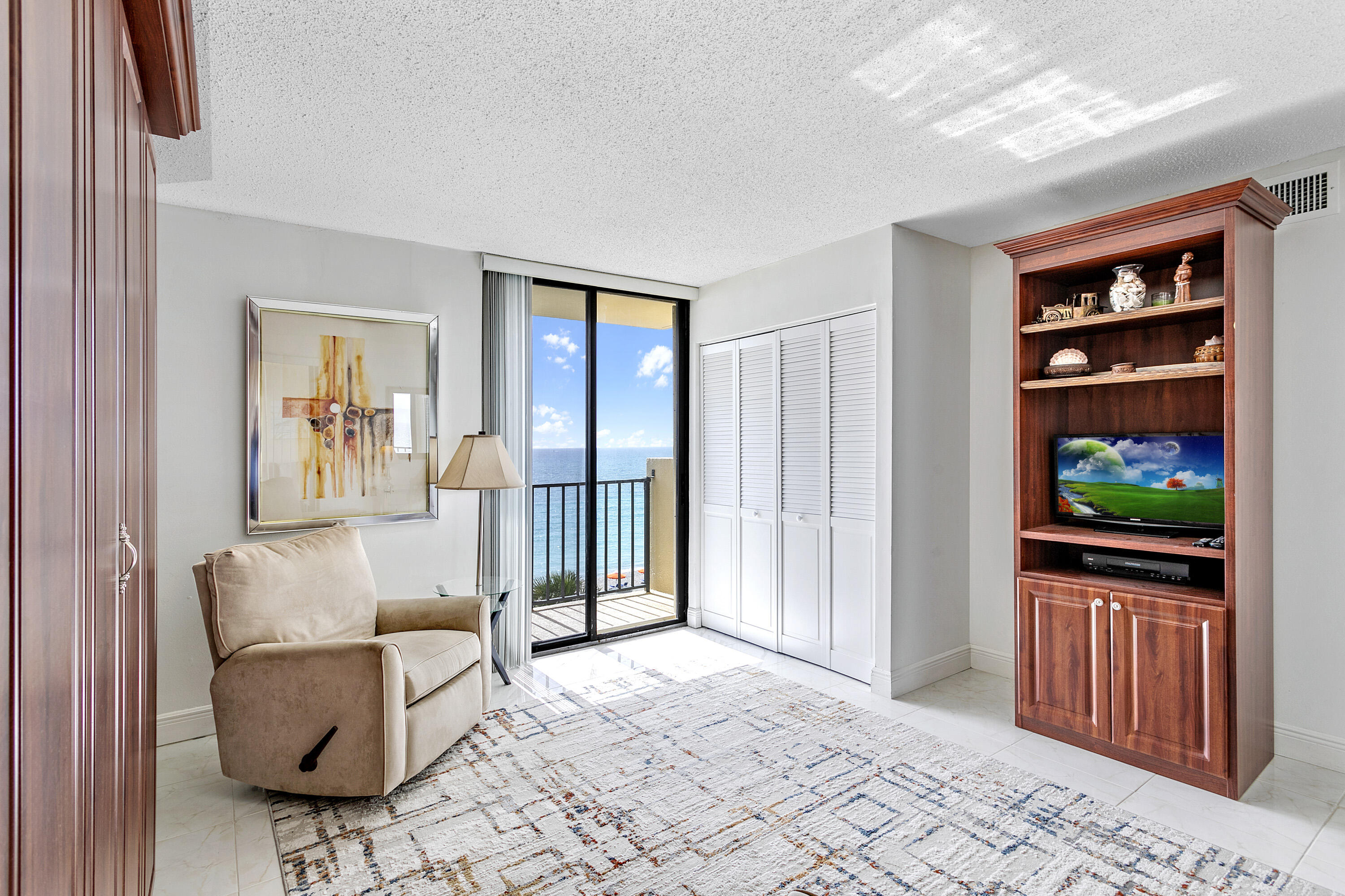 100 Ocean Trail Way, Unit 501 Jupiter, FL 33477 - Photo 18 of 30 a living room with furniture and a flat screen tv