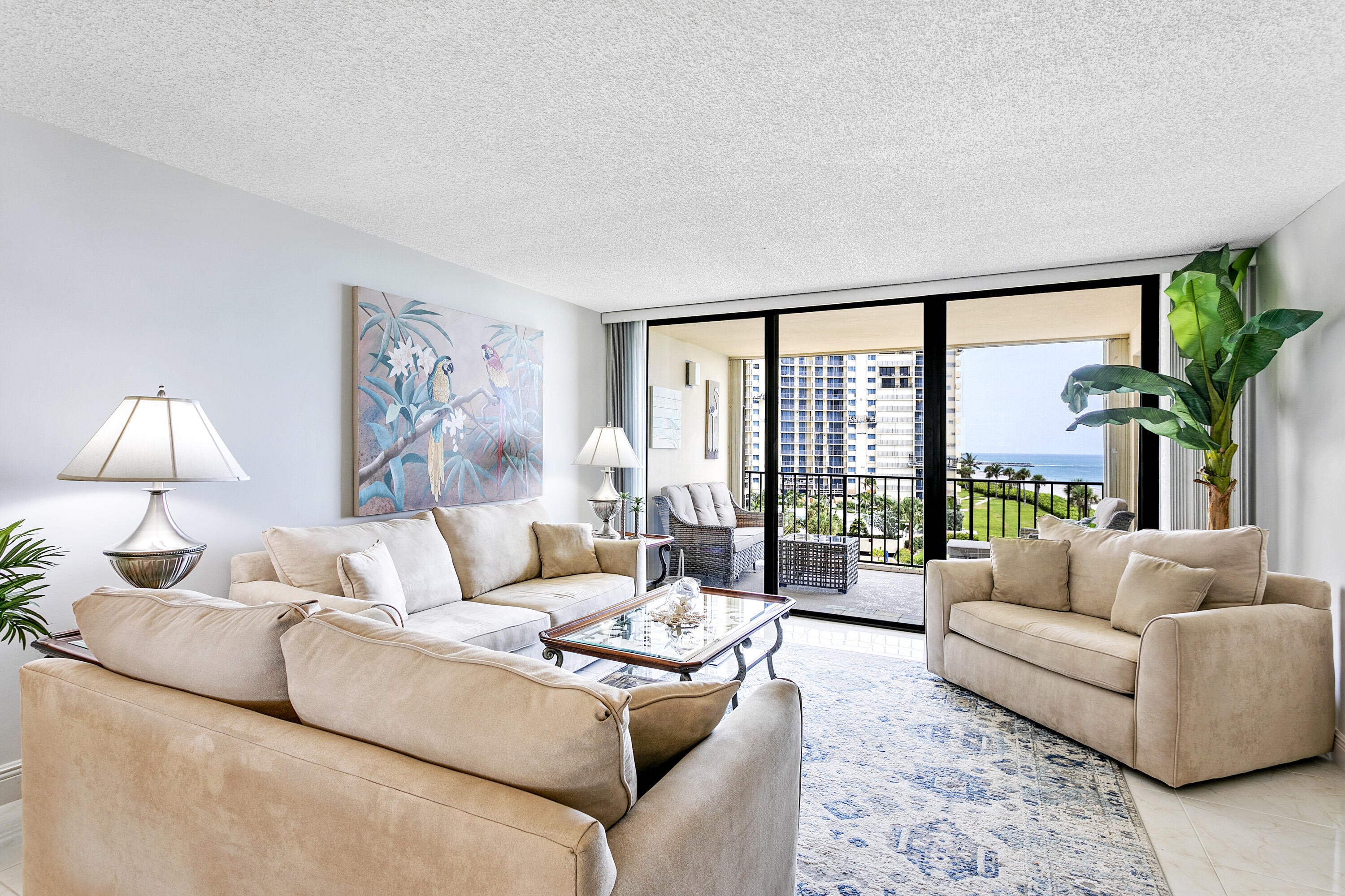 100 Ocean Trail Way, Unit 501 Jupiter, FL 33477 - Photo 4 of 30 a living room with furniture and a large window with balcony view