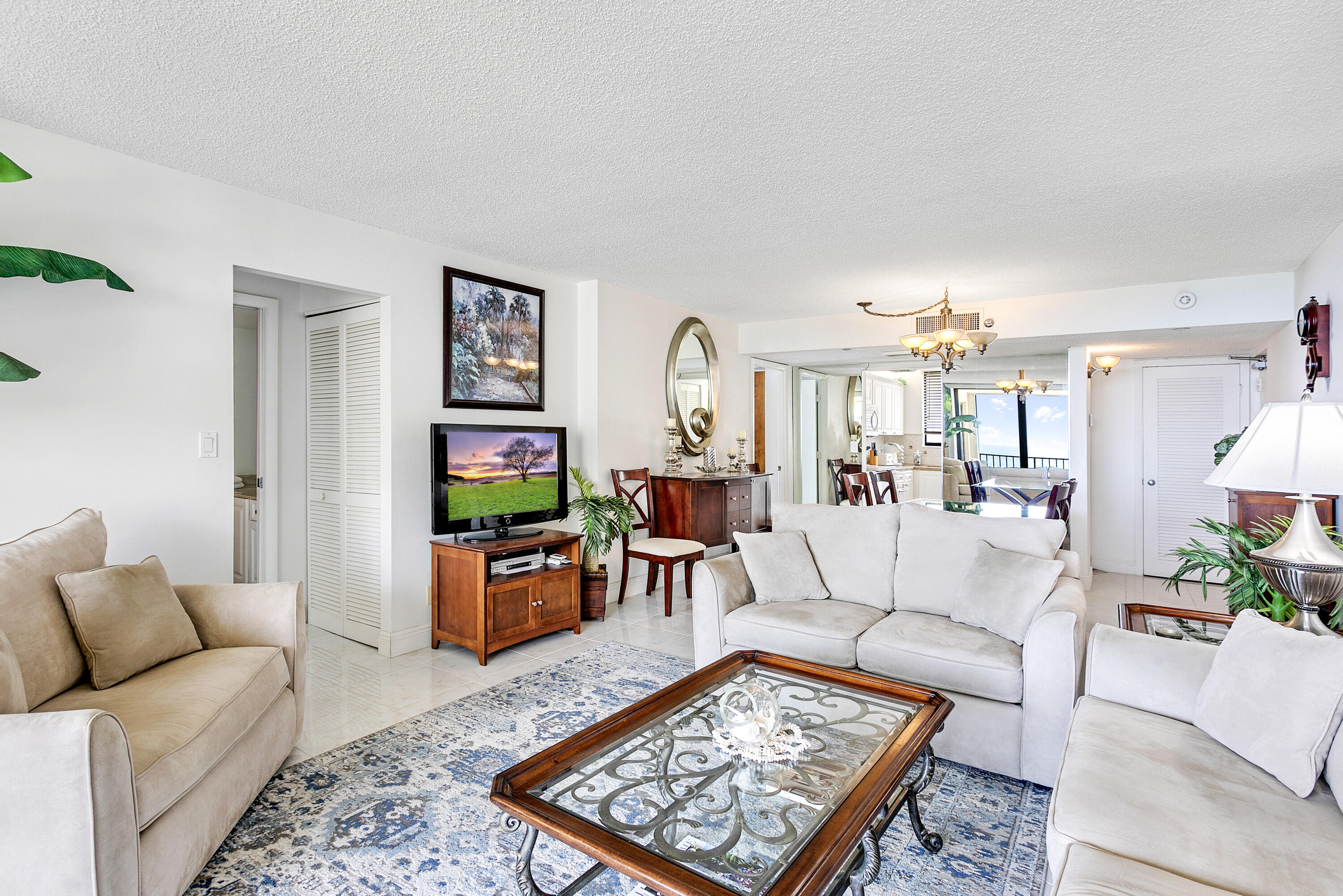 100 Ocean Trail Way, Unit 501 Jupiter, FL 33477 - Photo 6 of 30 a living room with furniture and a flat screen tv