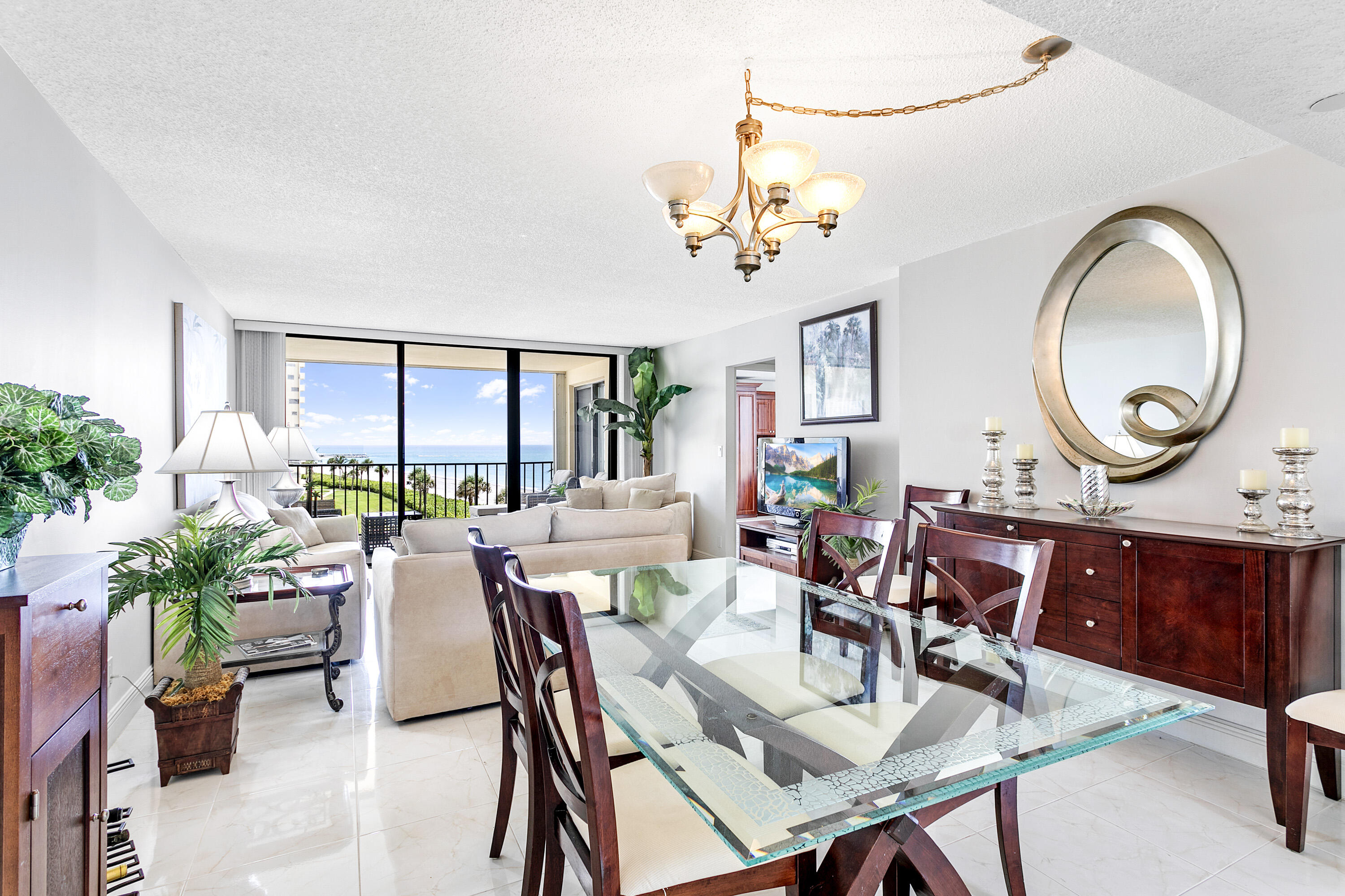 100 Ocean Trail Way, Unit 501 Jupiter, FL 33477 - Photo 7 of 30 a view of a dining room with furniture and chandelier
