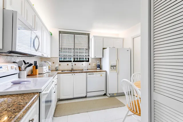 a kitchen with a sink stove and refrigerator