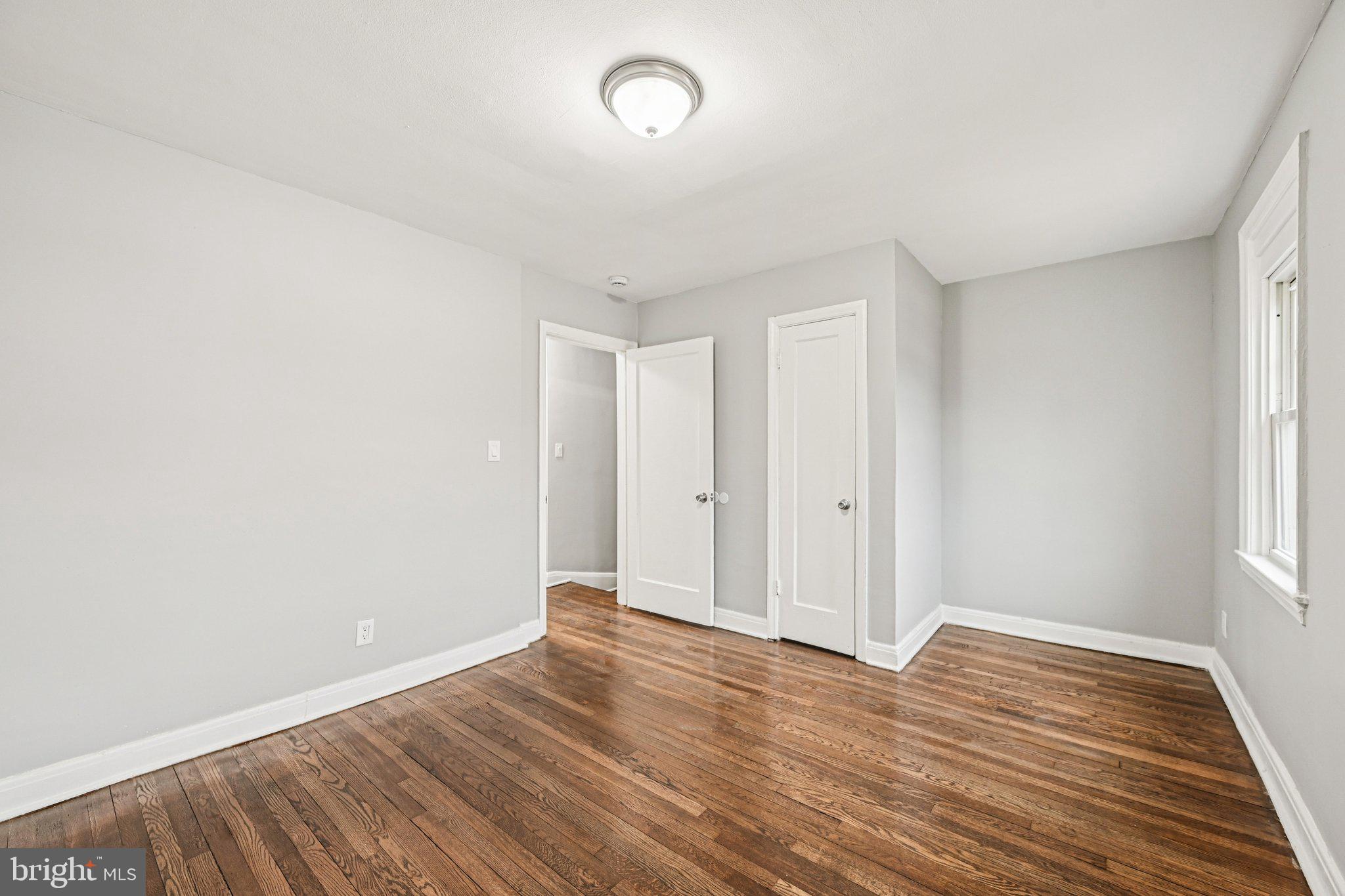 38 Upmanor Road Baltimore, MD 21229 - Photo 15 of 35 a view of an empty room with wooden floor and a window