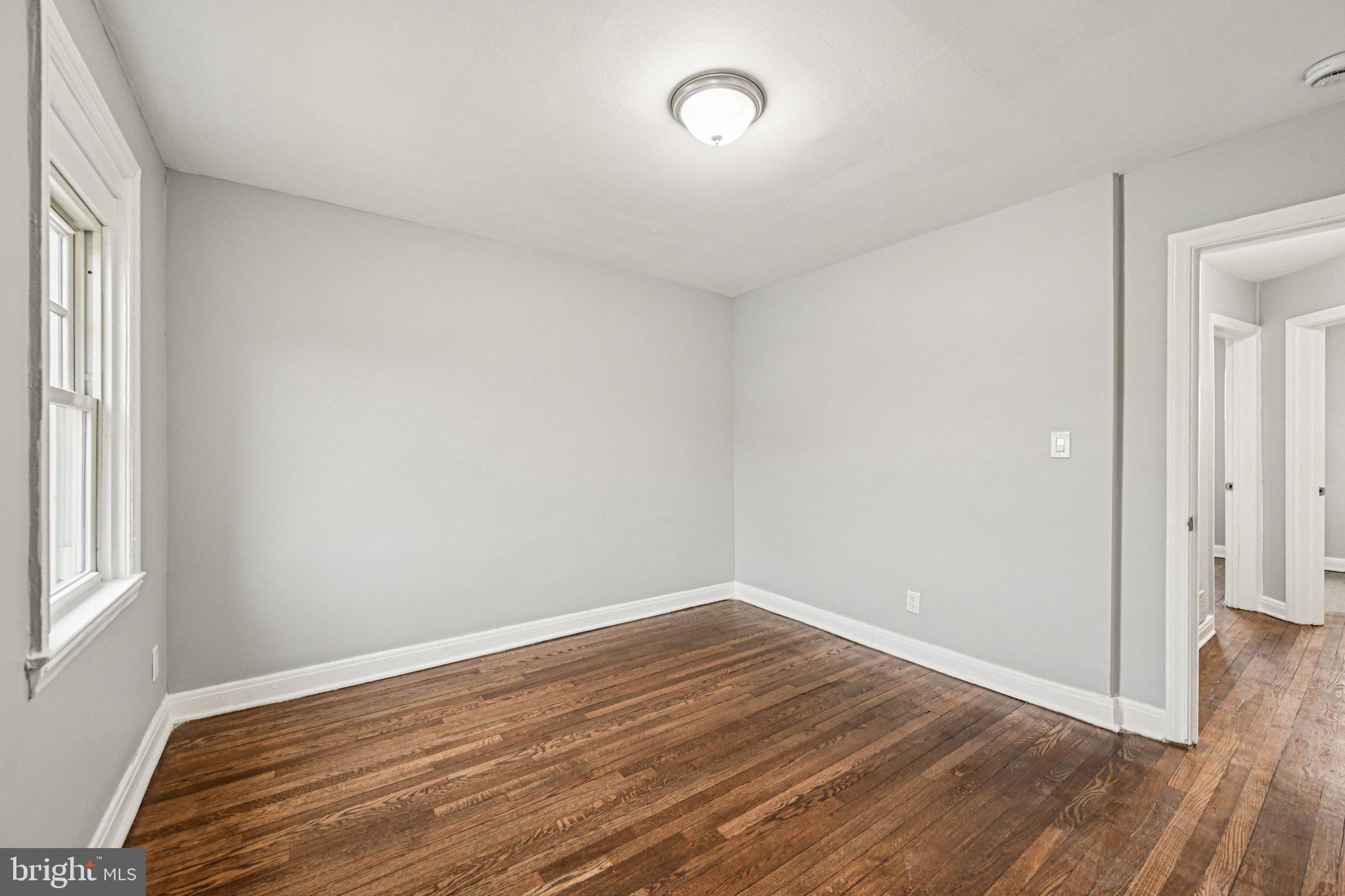 38 Upmanor Road Baltimore, MD 21229 - Photo 16 of 35 an empty room with wooden floor and windows