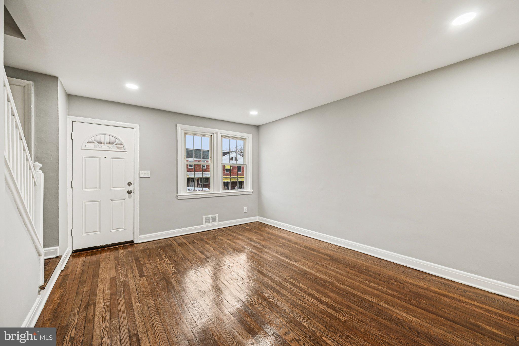 38 Upmanor Road Baltimore, MD 21229 - Photo 3 of 35 an empty room with wooden floor and windows