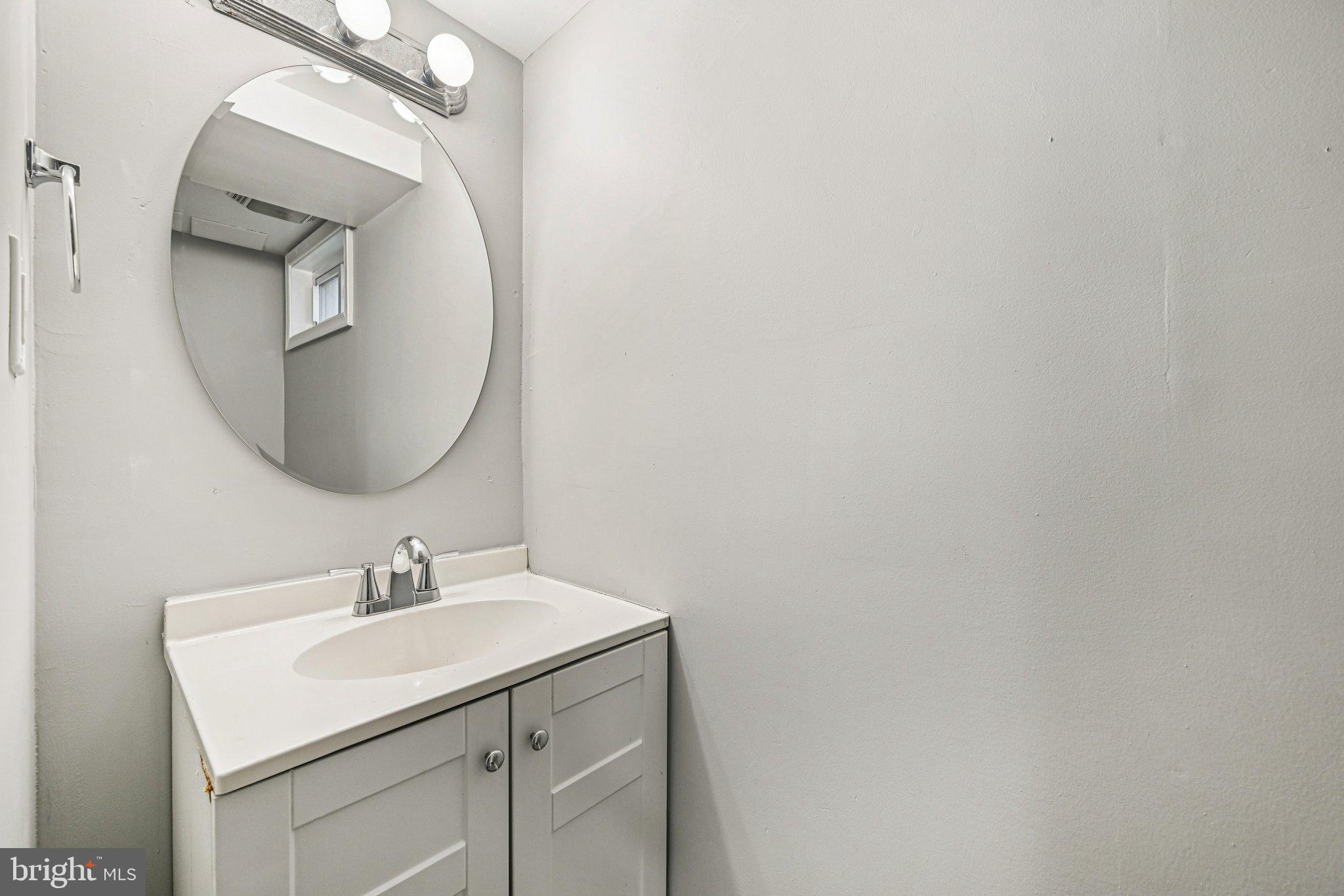 38 Upmanor Road Baltimore, MD 21229 - Photo 31 of 35 a bathroom with a sink and mirror