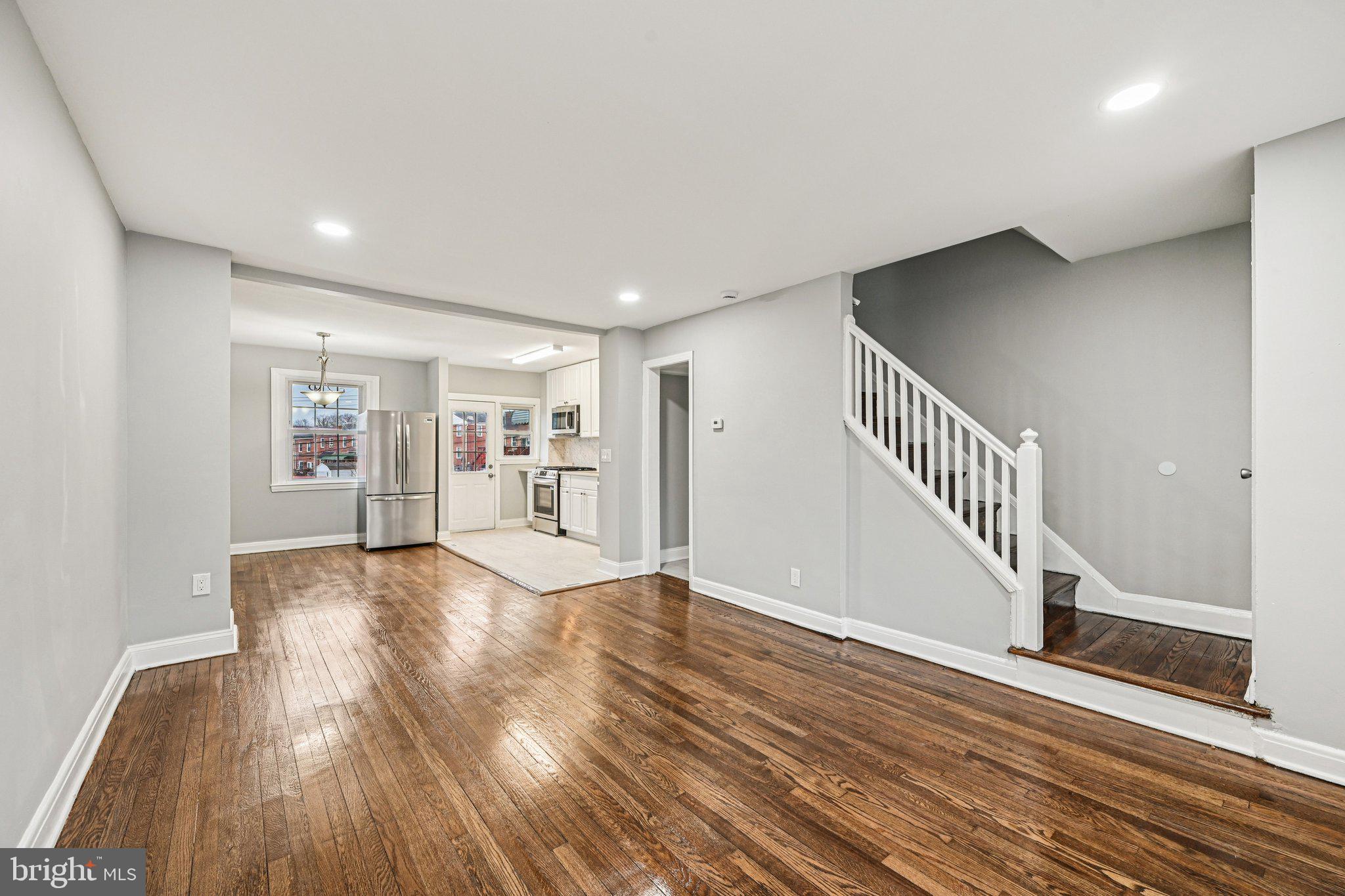 38 Upmanor Road Baltimore, MD 21229 - Photo 6 of 35 a view of an empty room with wooden floor and stairs