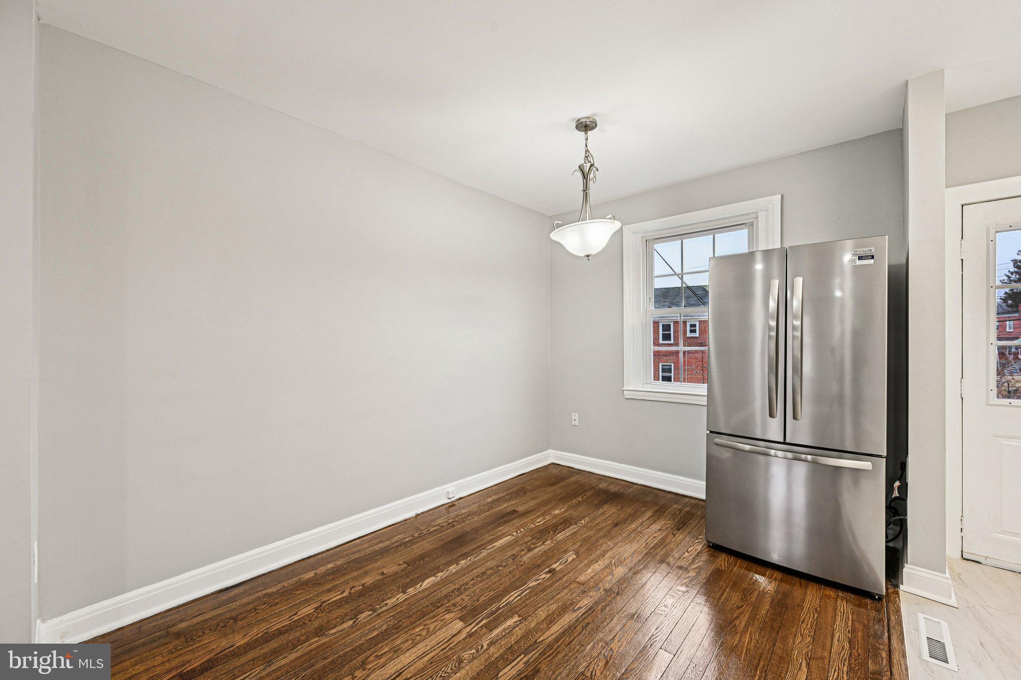 38 Upmanor Road Baltimore, MD 21229 - Photo 7 of 35 a view of a refrigerator in kitchen and wooden floor