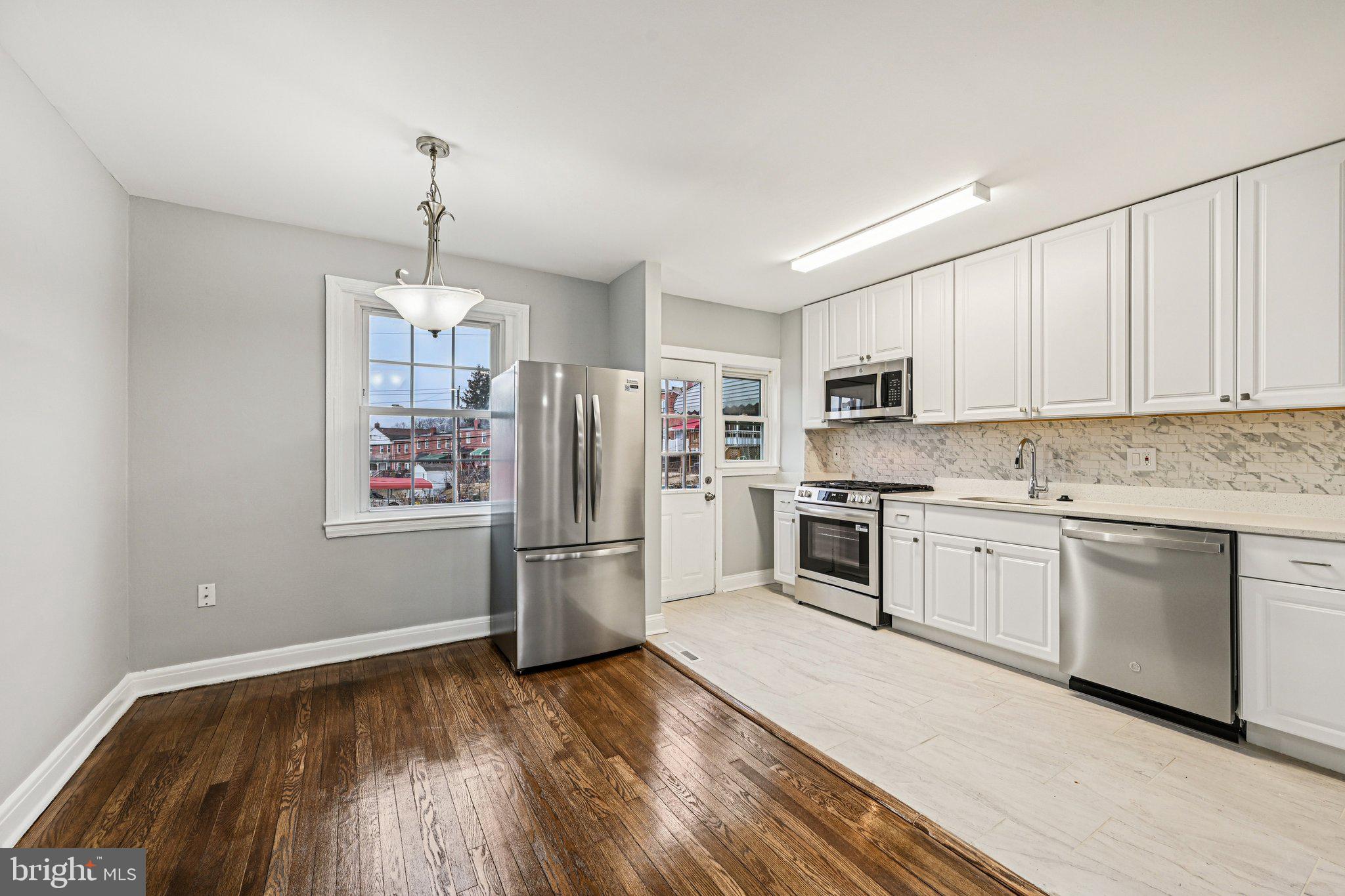 38 Upmanor Road Baltimore, MD 21229 - Photo 8 of 35 a kitchen with a refrigerator and white cabinets