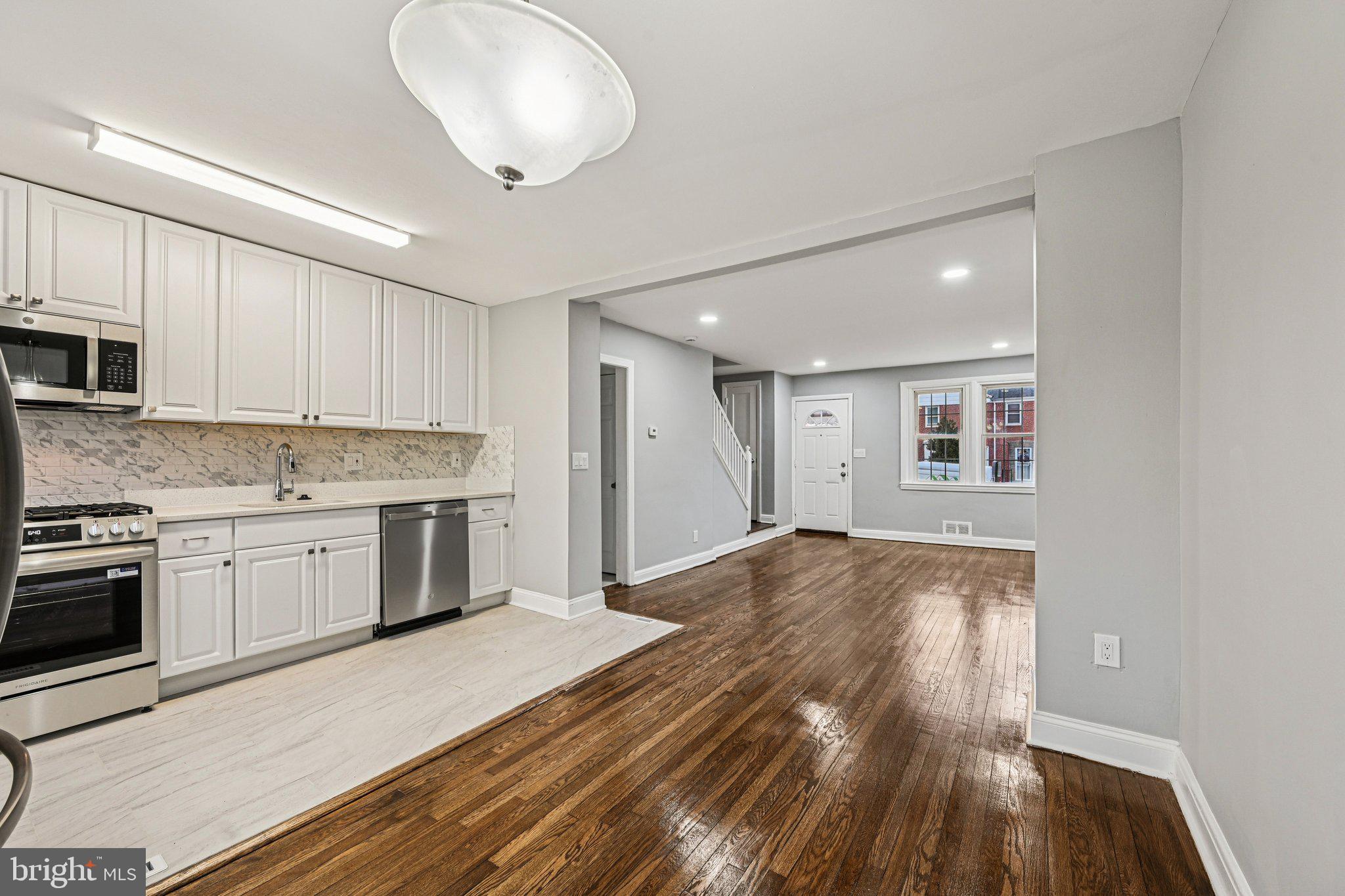 38 Upmanor Road Baltimore, MD 21229 - Photo 9 of 35 a kitchen with granite countertop a stove cabinets and wooden floor