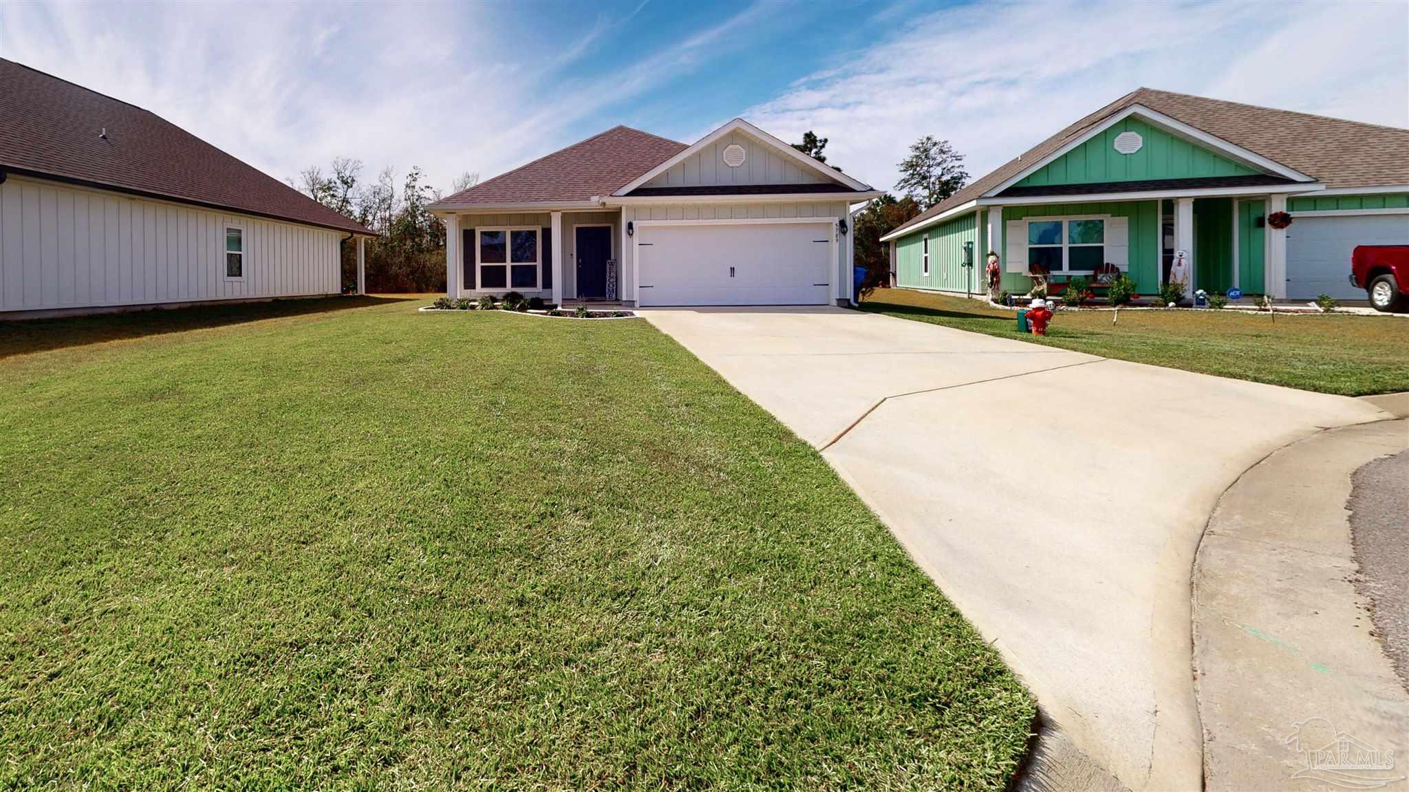 5789 Conley Court Milton, FL 32571 - Photo 2 of 50 a view of a white house with a big yard and potted plants