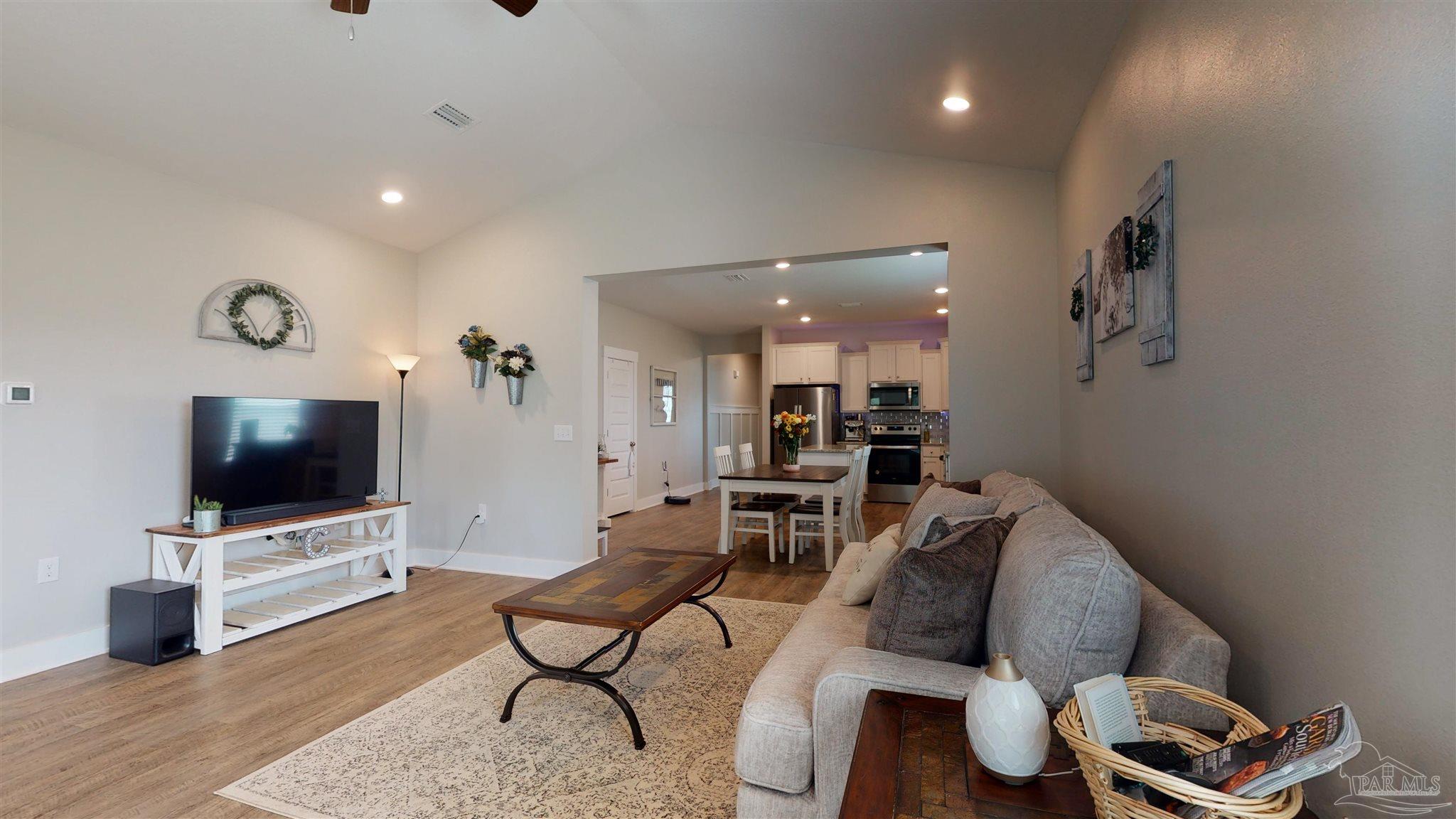 5789 Conley Court Milton, FL 32571 - Photo 12 of 50 a living room with furniture and a flat screen tv