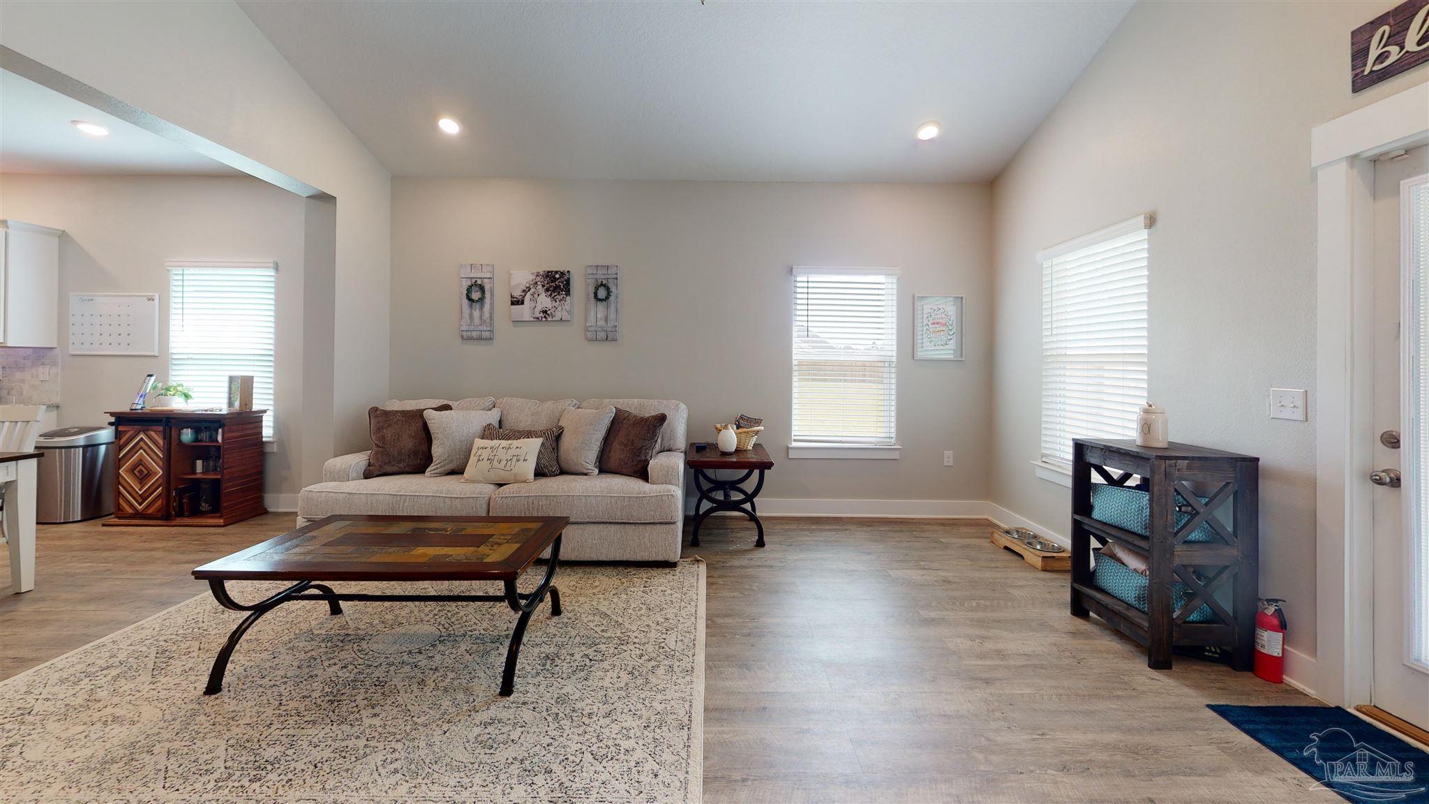 5789 Conley Court Milton, FL 32571 - Photo 13 of 50 a living room with furniture and a wooden floor