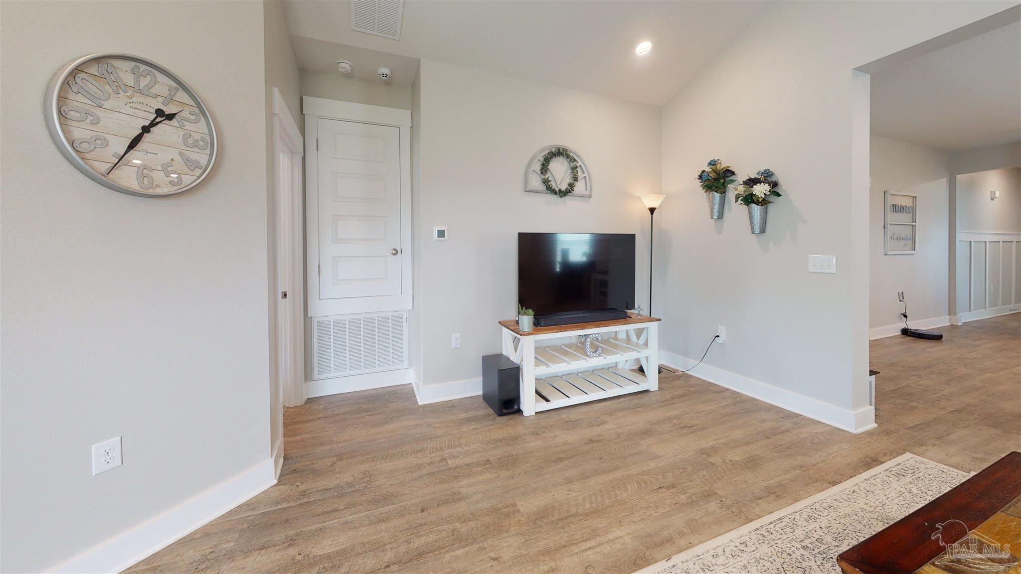 5789 Conley Court Milton, FL 32571 - Photo 14 of 50 a living room with furniture and a flat screen tv