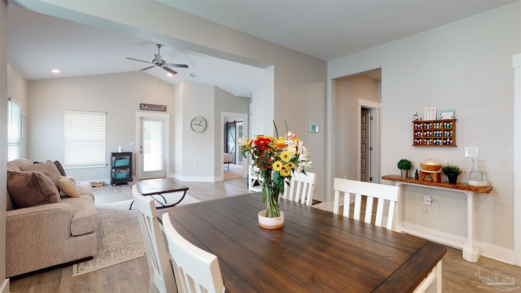 5789 Conley Court Milton, FL 32571 - Photo 18 of 50 a living room with furniture potted plant and wooden floor