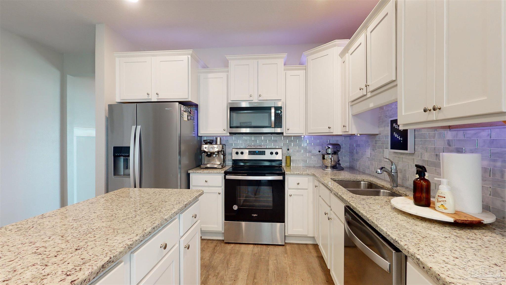 5789 Conley Court Milton, FL 32571 - Photo 19 of 50 a kitchen with a sink stove and refrigerator