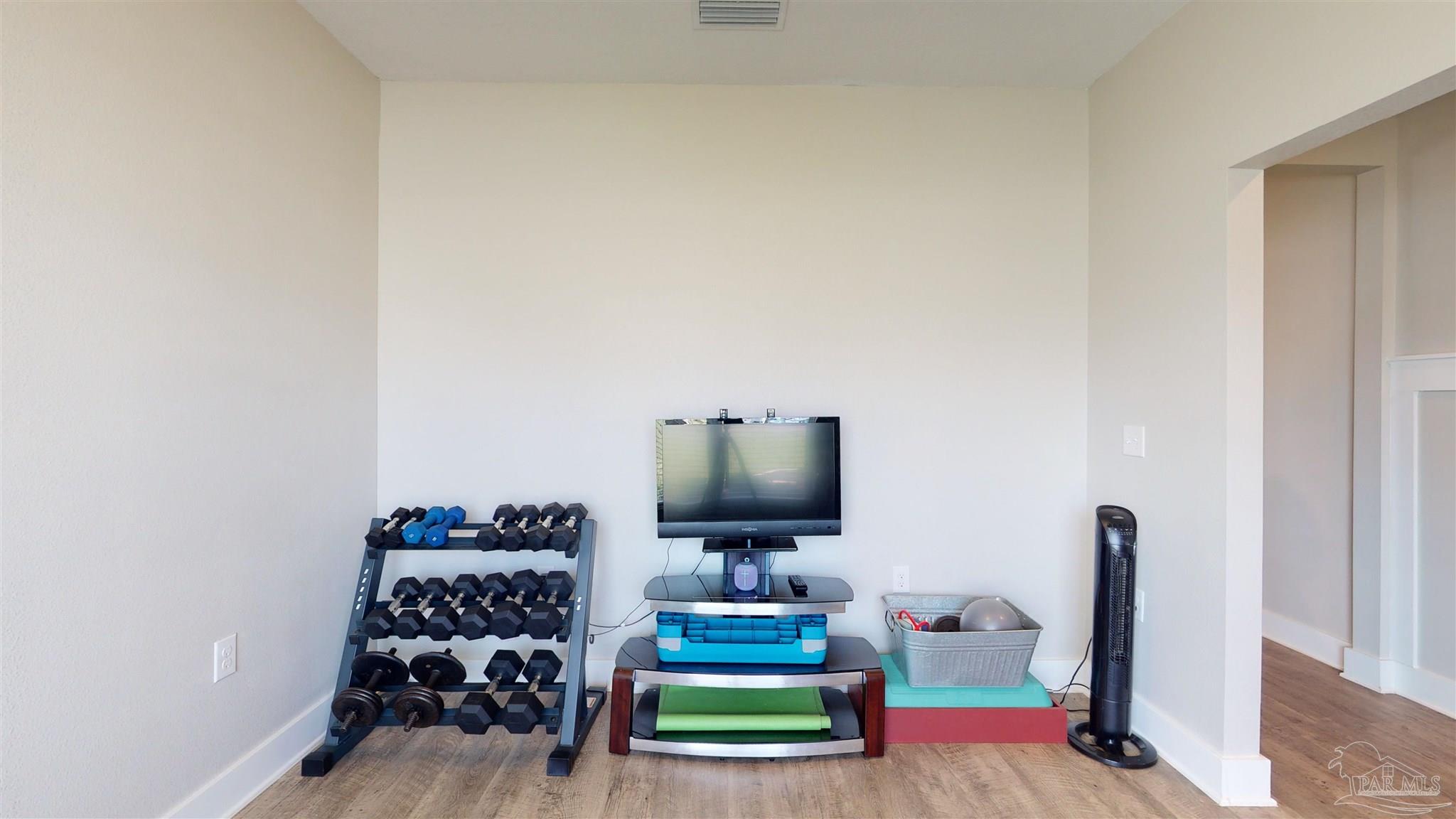 5789 Conley Court Milton, FL 32571 - Photo 23 of 50 a living room with furniture and a flat screen tv