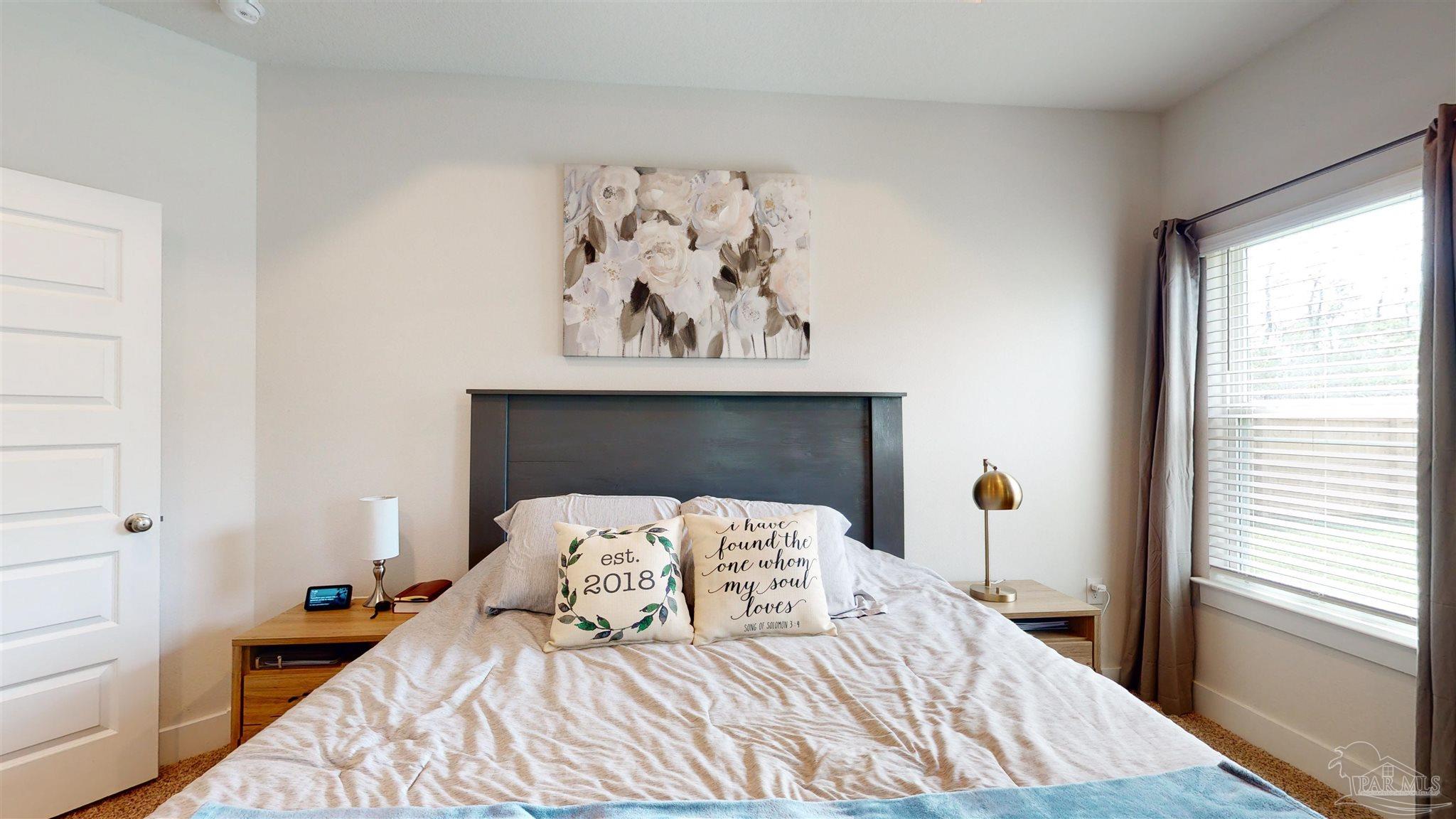 5789 Conley Court Milton, FL 32571 - Photo 27 of 50 a bedroom with a bed and a window